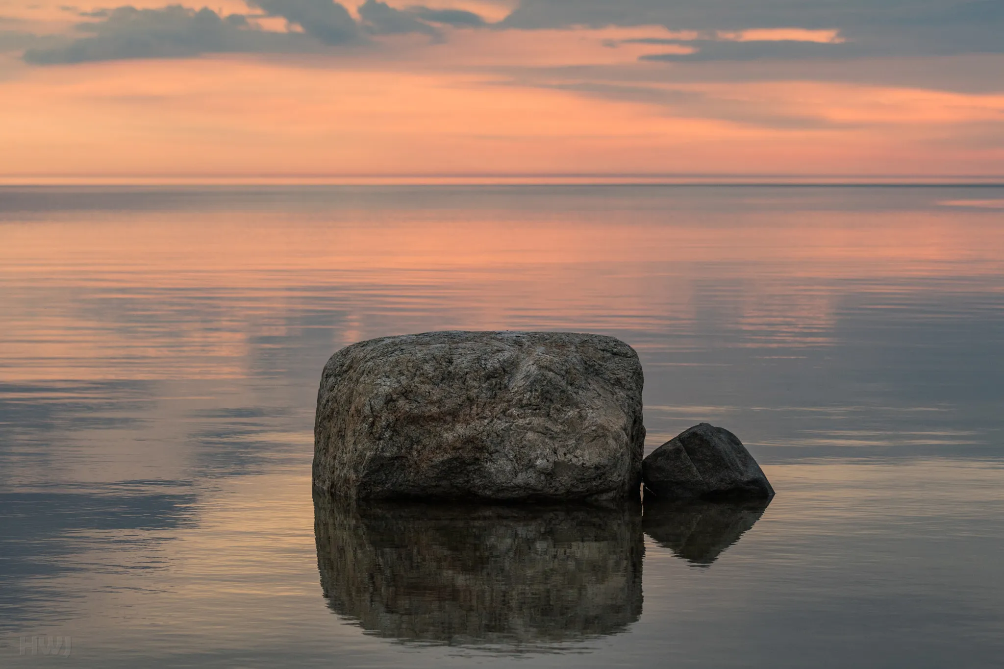 Photo showing: 500px provided description: The sea at our coastal cottage is rarely very calm, so this was a big surprise for me. Simple and beautiful [#sky ,#sea ,#sunset ,#water ,#reflection ,#nature ,#beach ,#travel ,#evening ,#calm ,#outdoors ,#dusk ,#serenity ,#no person ,#Luvia]