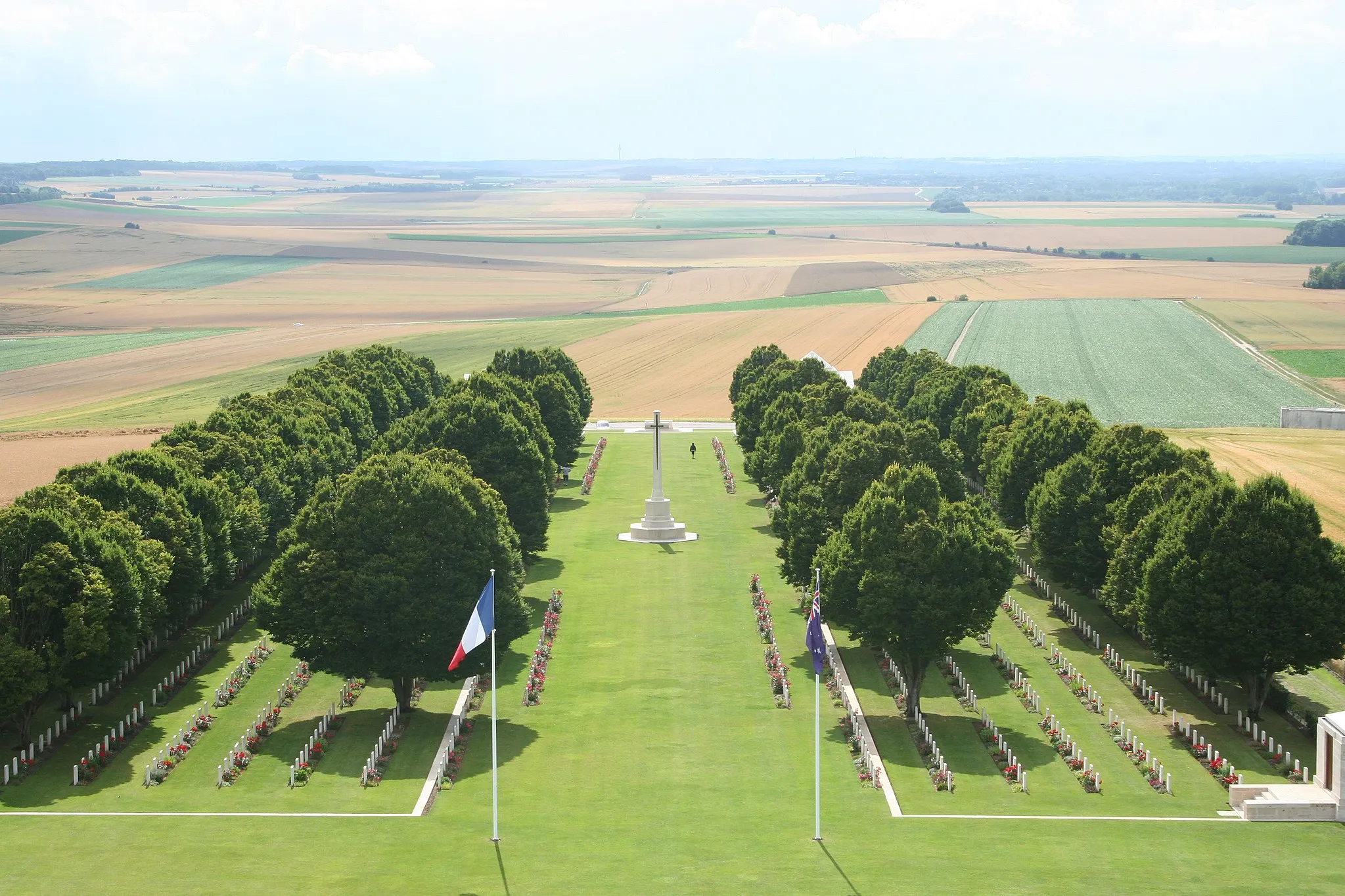 Photo showing: A view from the top of the Australian National Memorial at the Villers-Bretonneux Commonwealth War Graves Cemeterey showing the graves of over 770 Australian soldiers, as well as those of other Commonwealth soldiers involved in the campaign.There are now (July 2012) 2,142 Commonwealth servicemen of the First World War buried or commemorated in this cemetery. 609 of the burials are unidentified but there are special memorials to five casualties known or believed to be buried among them, and to 15 buried in other cemeteries whose graves could not be found on concentration. The cemetery also contains the graves of two New Zealand airmen of the Second World War.