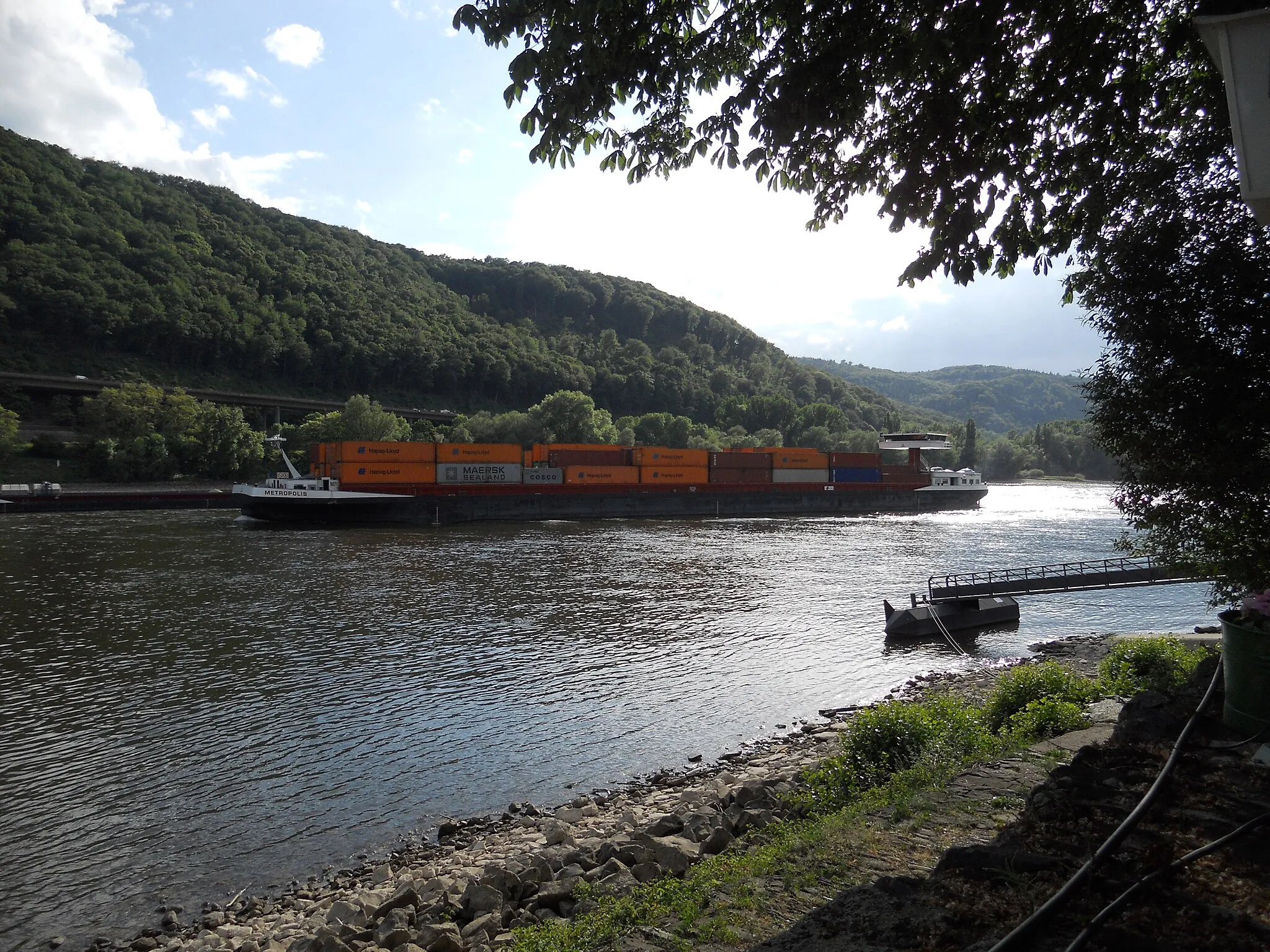 Photo showing: A containership arduously pushes its was upstream on the Rhine near Leutesdorf in Germany.