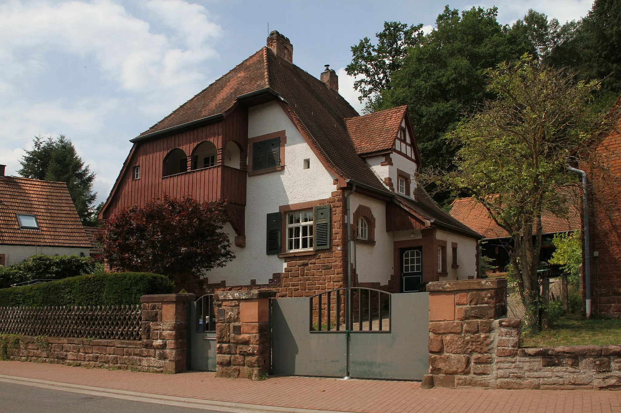 Photo showing: Bruchweiler-Bärenbach, Forstamt Im Grün 10; ehemaliges Forstdienstgebäude; eingeschossiger, reich gegliederter Krüppelwalmdachbau, um 1905/10.