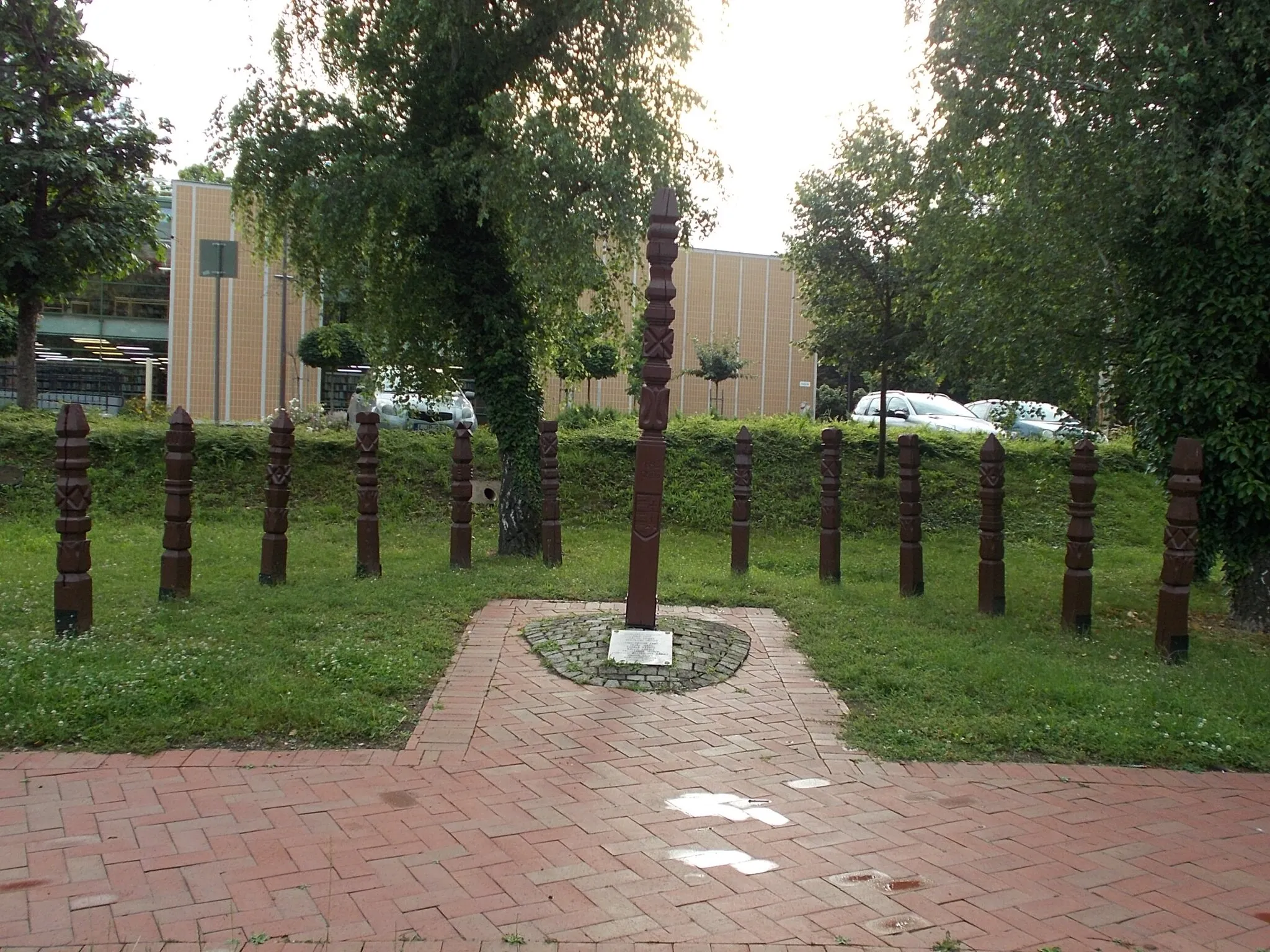 Photo showing: 'In memory of the martyrs of Arad' A Memorial to the 13 martyrs of Arad by József Miklós woodcarver  (Installed for the 150th anniversary in 1989), This is a kopjafa group memorial and a ground based plaque with names of the martyrs. - in a small Park (Martyrs of Arad Grove?) at Derkovits Street and Kiss Ernő Street corner, Békéscsaba, Békés County, Hungary.