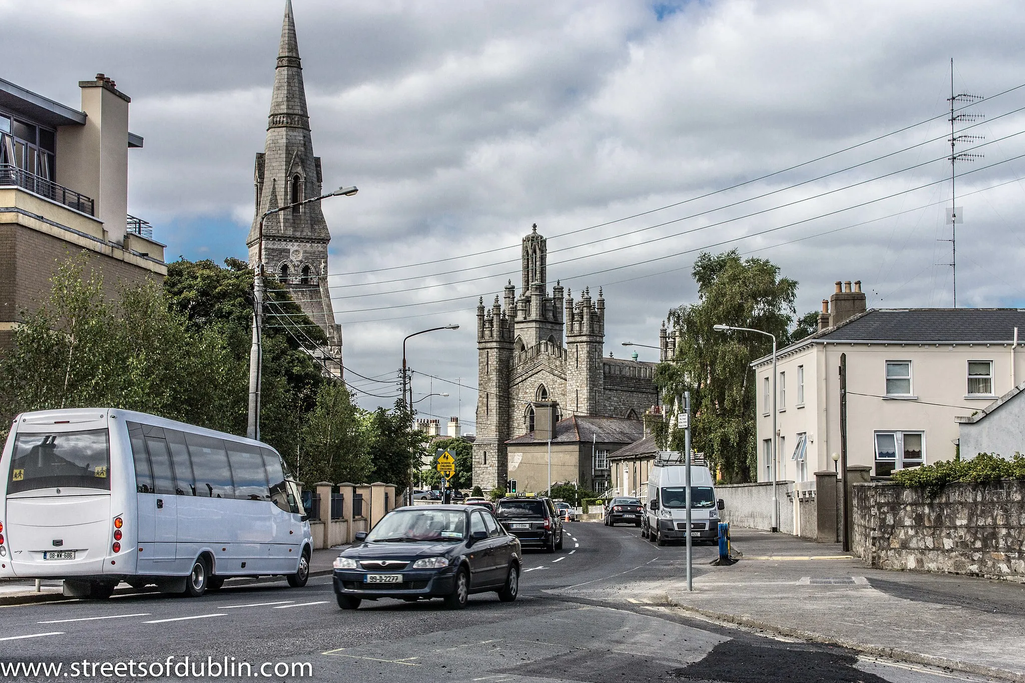 Photo showing: Monkstown, historically known as Carrickbrennan (Irish: Carraig Bhraonáin), is an area in south Dublin, located in Dun Laoghaire-Rathdown County, Ireland. It is on the coast, between Blackrock and Dún Laoghaire. The DART stations of Seapoint and Salthill and Monkstown serve the area.
In 1539, King Henry VIII awarded the Monkstown lands to Sir John Travers, Master of the Ordnance in Ireland. John Travers lived in his Castle at Monkstown from 1557 to his death in 1562 and is buried in the Carrickbrennan Graveyard where the property fell to James Eustace 3rd Viscount Baltinglass through his marriage to Mary Travers. In 1580, the Castle was used as a rebellion stronghold, after which it was awarded to Sir Henry Wallop, Vice-Treasurer of Ireland. The lands were later returned to Mary, the widow Baltinglass, who later married Gerald Alymer. On her death in 1610 the Castle was transferred to the Chevers family through the marriage of Mary Travers's sister Catherine to John Chevers, and the property passed directly to his second son Henry Chevers, who married Catherine, daughter of Sir Richard Fitzwilliam. Henry and Catherine Chevers lived here with their four children (Walter, Thomas, Patrick, Margaret).
Upon the death of Henry in 1640, the castle and lands were passed to Walter Cheevers. Walter and family were given command to vacate Monkstown in 1653 by the Cromwellian Commissioners, and transplanted to Killyan, County Galway. In 1660, Walter Chevers was restored to his estate at Monkstown Castle, until his death in 1678.
Monkstown was later purchased by Bishop of Armagh Michael Boyle where his son Murragh, Viscount Blessington enlarged the castle making it one of the finest residences.
Until about 1800, Monkstown was a rural area of open countryside, dotted here and there with large houses owned by the merchants of Dublin. The Monkstown Church (Church of Ireland) had been built - but was smaller than the present church. Two rivers met in the area now called Pakenham Road. The river known as Micky Briens originated in Sallynoggin. A lake beside Monkstown Castle had one small island. The coastline was ragged and rocky, with a harbour stretching over 100 yards inland at the mouth of the aforementioned rivers, adjacent to the area now occupied by the West Pier. Dun Laoghaire (then called Dunleary, and later Kingstown) was then a small group of houses in the area of the Purty Kitchen, and the present area of Dún Laoghaire was an area of rocky outcrops and later, quarries.
Wednesday, November 18, 1807 was South Dublin's night of disasters. In an horrific storm, two sailing ships, the Rochdale and the Prince of Wales were blown on to the rocks, one at Seapoint and the other at Blackrock. About 400 lives in total were lost on that night, many of them washed up on the shore at Monkstown. The disaster was one of the factors which led to the building of Dun Laoghaire Harbour. Most of the victims were buried in Carrickbrennan Churchyard.
The building of Dun Laoghaire harbour gave an impetus to the area, and Montpelier Terrace was the first of many terraces built in the area. The coming of the railway in 1837 had a much greater impact. Firstly, it changed the topology of the coast, and secondly, it led to Monkstown becoming a commuter suburb of the city of Dublin. Most of the houses along Monkstown Road and the avenues north of that road were constructed over the next 30 years. The maps of 1870 show this phase completed, but the rest of Monkstown consists of mansions surrounded by extensive gardens. For the following 50 years there was little change. The post-war developments of Castle Park, Richmond, Windsor, etc. and the more recent developments of Brook Court, Monkstown Valley, and Carrickbrennan Lawn mean that there is little opportunity for further development.

The diaries of the Rev John Thomas Hynes(1799-1868), a Catholic bishop who retired to Monkstown in 1861-1868 provide a valuable insight into daily life in Monkstown in that period. Hynes lived at Bloomwood, Monkstown Avenue (later renamed as Carrickbrennan Road), and later moved to Uplands, The Hill, Monkstown. The Hynes Diaries recount such details as the coming of gas lighting, the postal and travel facilities, church affairs, and lots of local gossip. The Hynes diaries are now preserved in Melbourne, but the full text has been made available online at www.unisanet.unisa.edu.au/research/condon/Hynes/index.htm