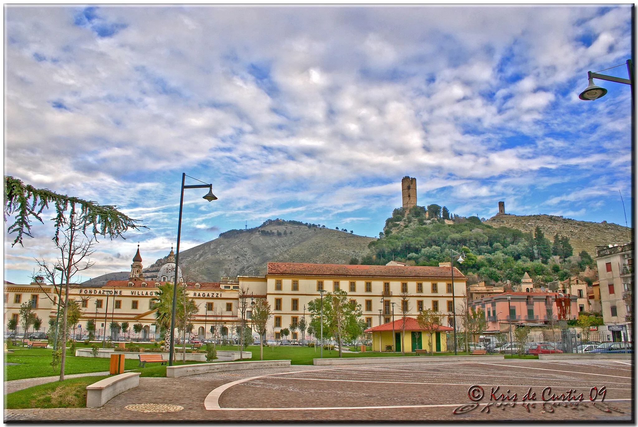 Photo showing: Maddaloni, my City. View of a foreshortened from the place where I currently work.
Maddaloni, ancient town in Campania (it was inhabited since copper age), is positioned on the slopes of Tifatini Mounts and has an half circle shape.  It is overlooked by the Medieval Castle and by the Longobard tower.
From the St. Michael mount, whose name is derived from the church name, it is possible to admire the town and the Great Valley where there's the Carolingian aqueduct and Vanvitellian Bridges. You can see also the neapolitan coast with the majestic Vesuvius and Capri island (when there's a clear sky).
________________________________________________________________________
Maddaloni, la mia città. Scorcio dal posto dove lavoro attualmente.
Maddaloni, antica città della Campania (fu abitata fin dall'età del rame), adagiata a semicerchio alle pendici dei monti Tifatini, è sovrastata dal Castello Medioevale e 
dalla Torre Longobarda.
Dal monte S. Michele, che prende il nome dalla omonima chiesa, si gode un'ampia vista sulla città, sulla Grande Vallata dove si trova l'acquedotto Carolino e i Ponti di Vanvitelli, e all'orizzonte, anche sul panorama della costa Napoletana con il maestoso
Vesuvio e l'Isola di Capri (nelle giornate abbastanza nitide).
________________________________________________________________________

Best View: Large On Black.