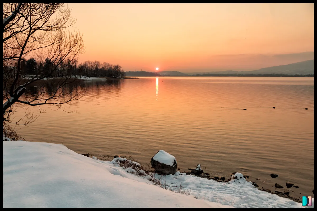 Photo showing: 500px provided description: Late afternoon at Pusiano lake, I was the only living being in the neighborhood...a very very nice moment. [#lake ,#sunset ,#winter ,#water ,#reflection ,#snow ,#emidellizuani]