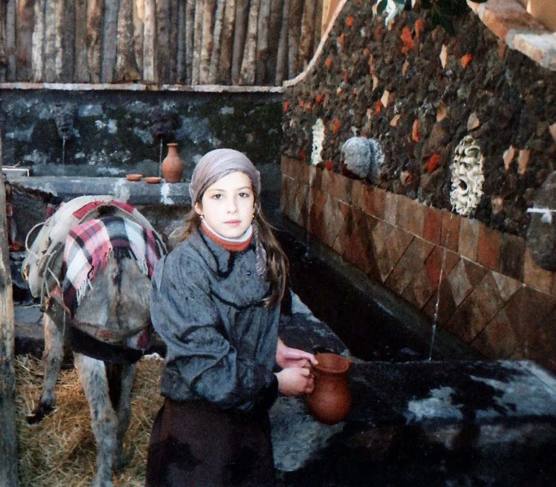 Photo showing: A young Sicilian artisan preparing the set for a living Nativity scene in Santa Maria La Stella, Sicily