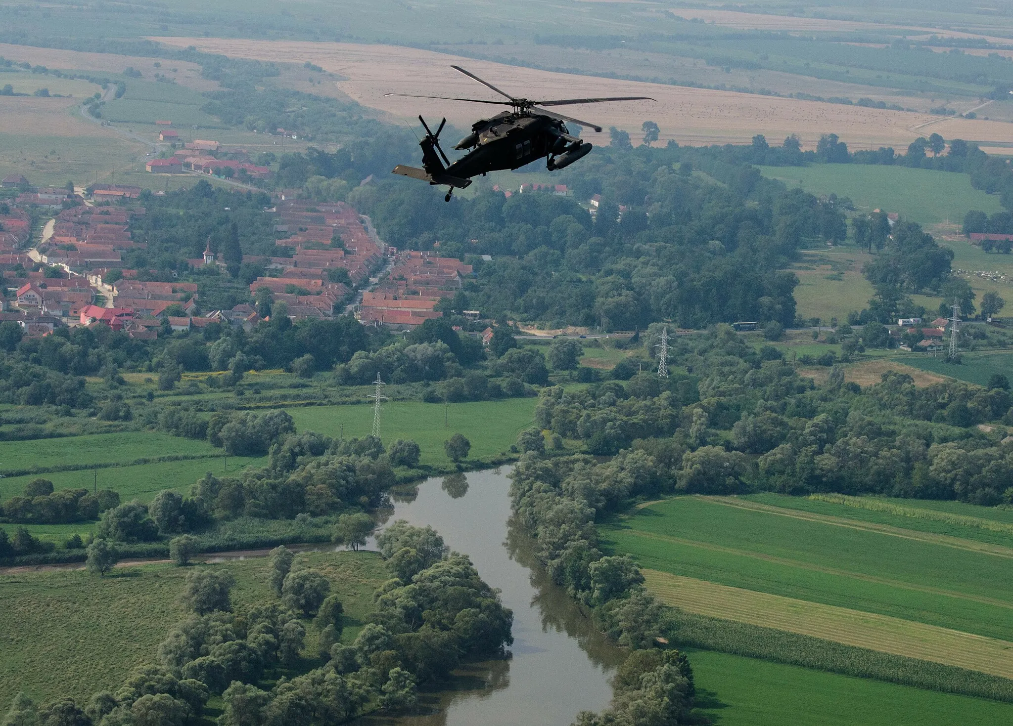 Photo showing: A UH-60 Blackhawk helicopter with Company C, 3rd Battalion, 501st Aviation Regiment performs flight maneuvers near the town of Voila, Romania, July, 29 during the Saber Guardian exercise that took place at the Romanian Land Forces Combat Training Center in Cincu, Romania. Saber Guardian is a multinational military exercise involving approximately 2,800 military personnel from ten nations including Armenia, Azerbaijan, Bulgaria, Canada, Georgia, Moldova, Poland, Romania, Ukraine and the U.S. (U.S. Army photo by Spc. Timothy Jackson, 115th Mobile Public Affairs Detachment, Oregon Army National Guard).
Unit: 115th Mobile Public Affairs Detachment