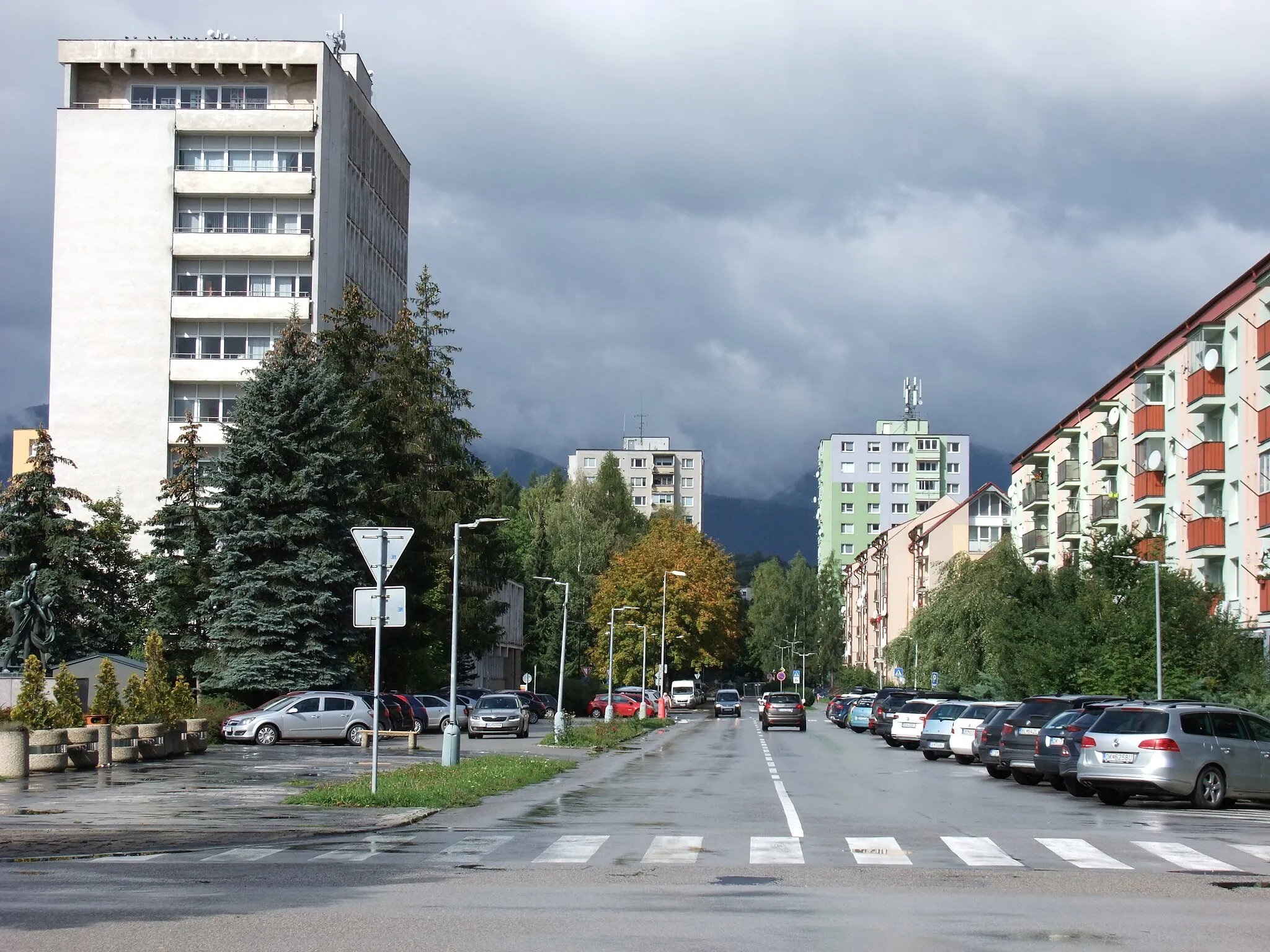 Photo showing: On the right side of the photo is SNP street, on the left is Námestie slobody (the Freedom Square). Bysterec, a district of Dolný Kubín, Slovakia. Weather: the weather was changeable all day, cloudy, sometimes the sun shone, sometimes it rained, a cold wind blew. Air temperature at the time this photo was taken: 13°C.