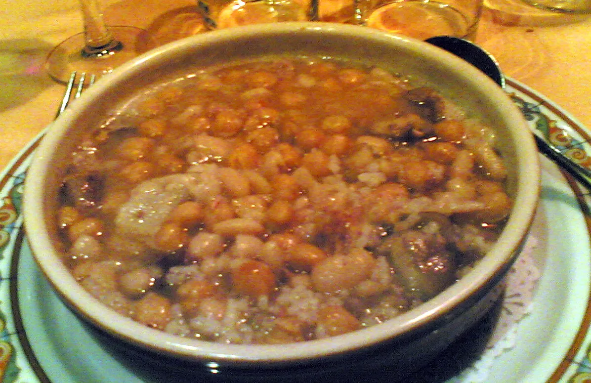 Photo showing: Plato típico de Granada, de la época de San Antón. Puchero con muchas cosas, contundente, con morcilla y chorizo. Éste, en concreto, en La Pataleta.