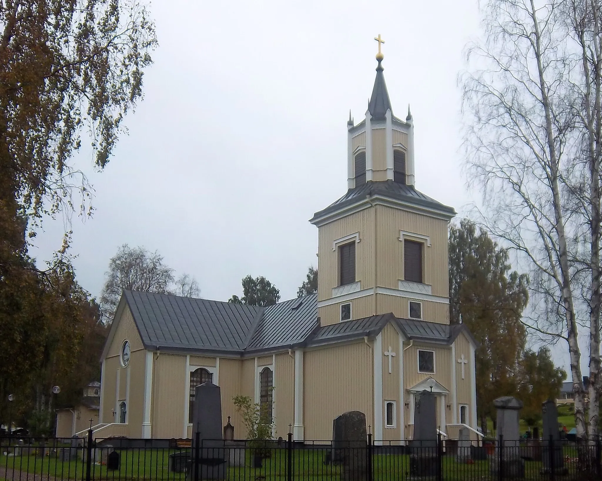 Photo showing: Älvsbyn church on a cloudy day in the fall, photographed between the church and the church village