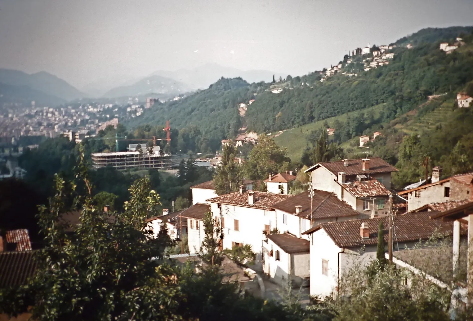 Photo showing: Photographed from the balcony where I lived for 20 years from 1974 to 1994
Photo analog (rephotographed) shot in 1975 in Canobbio, Ticino, Switzerland.  Foreground is Canobbio, with Lugano in the left background and Porza in the right background on the hill