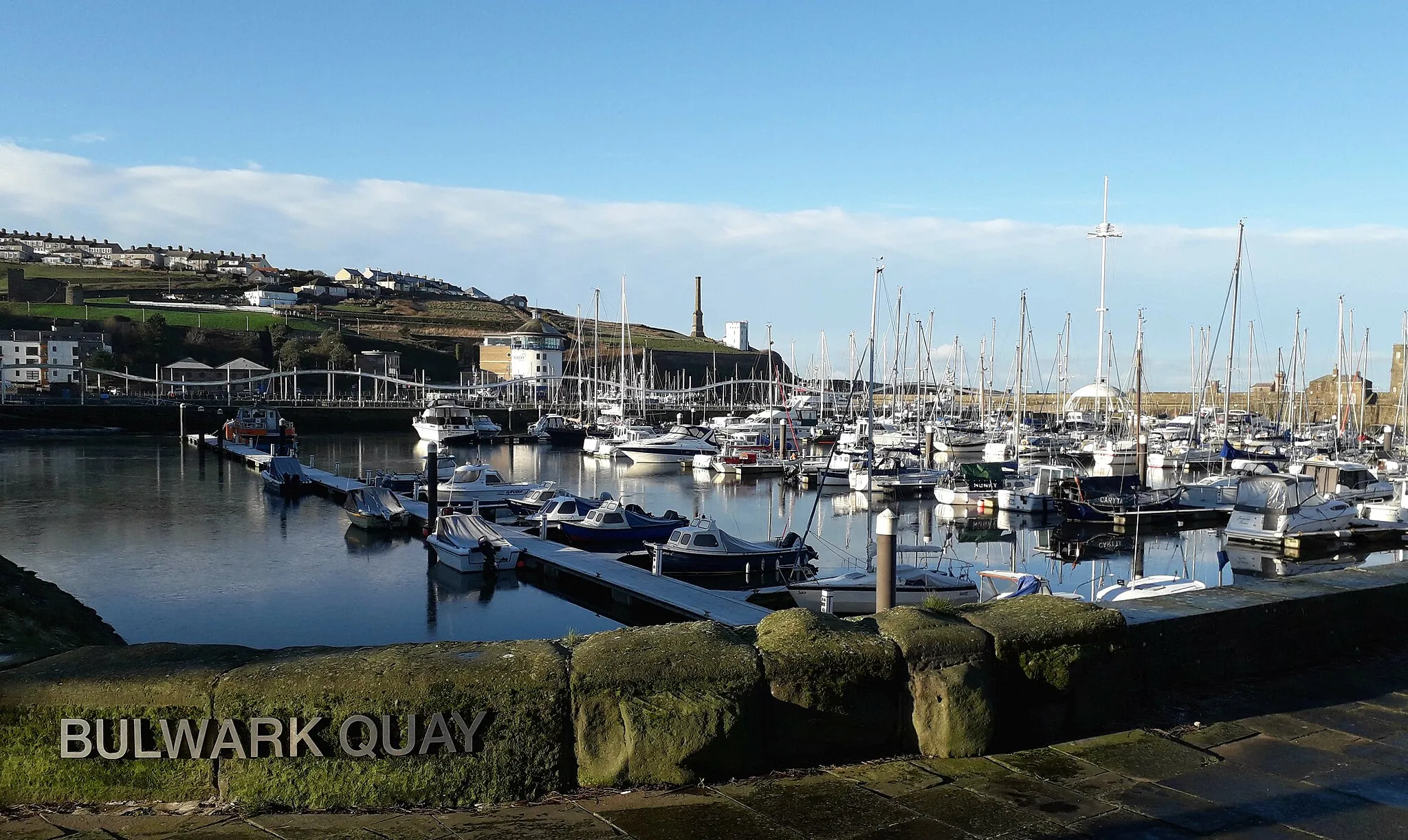 Photo showing: The impounded Whitehaven  marina with beacon museum and chimney from Wellington pit in the background