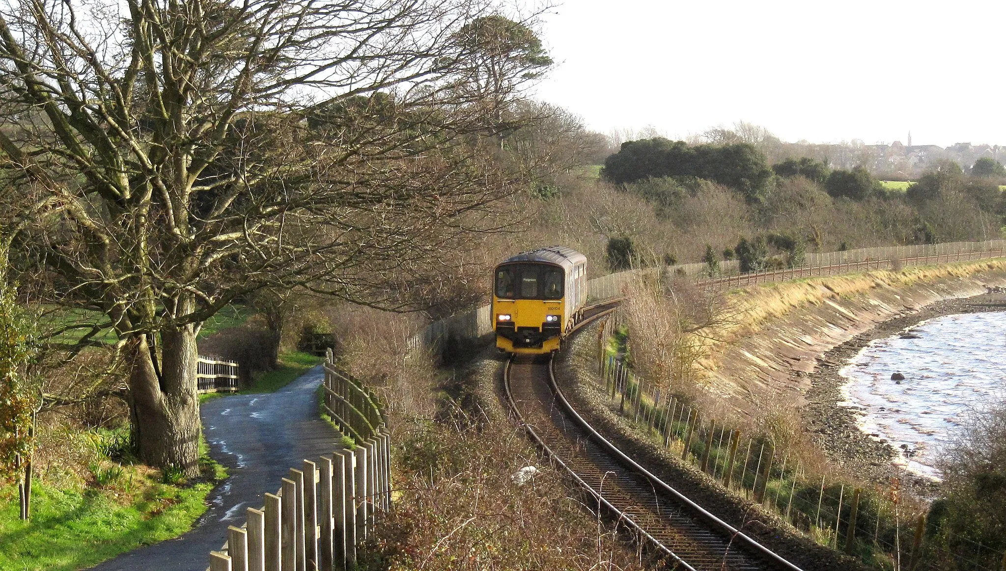 Photo showing: My last railway photographs for 2017 were taken from the excellent Exe Estuary Trail, which parallels the Exeter-Exmouth branch line. The trains are a mix of Class 150 and 143 units in a variety of liveries - nothing special, but likely to be replaced fairly soon. It's a delightful walk with spectacular views over the estuary and plenty of trains on both sides of the river to keep me amused!