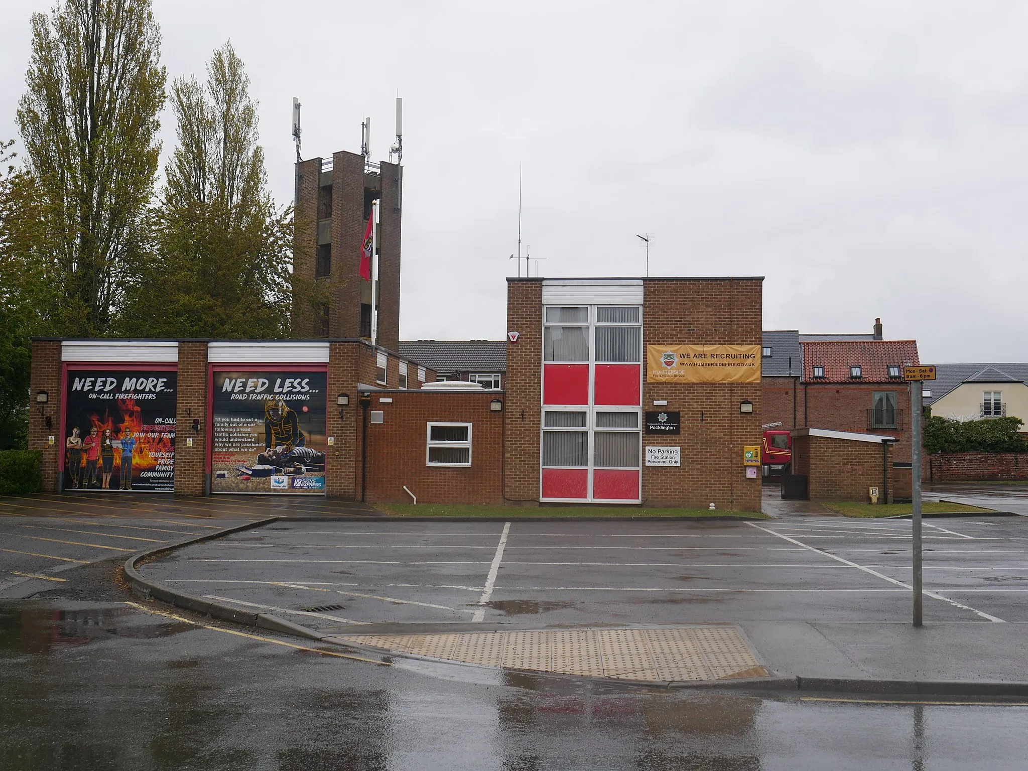 Photo showing: Pocklington's fire station along the B127. Note that the shutters have been covered with recruitment advertisement wraps by the Hull branch of Signs Express.