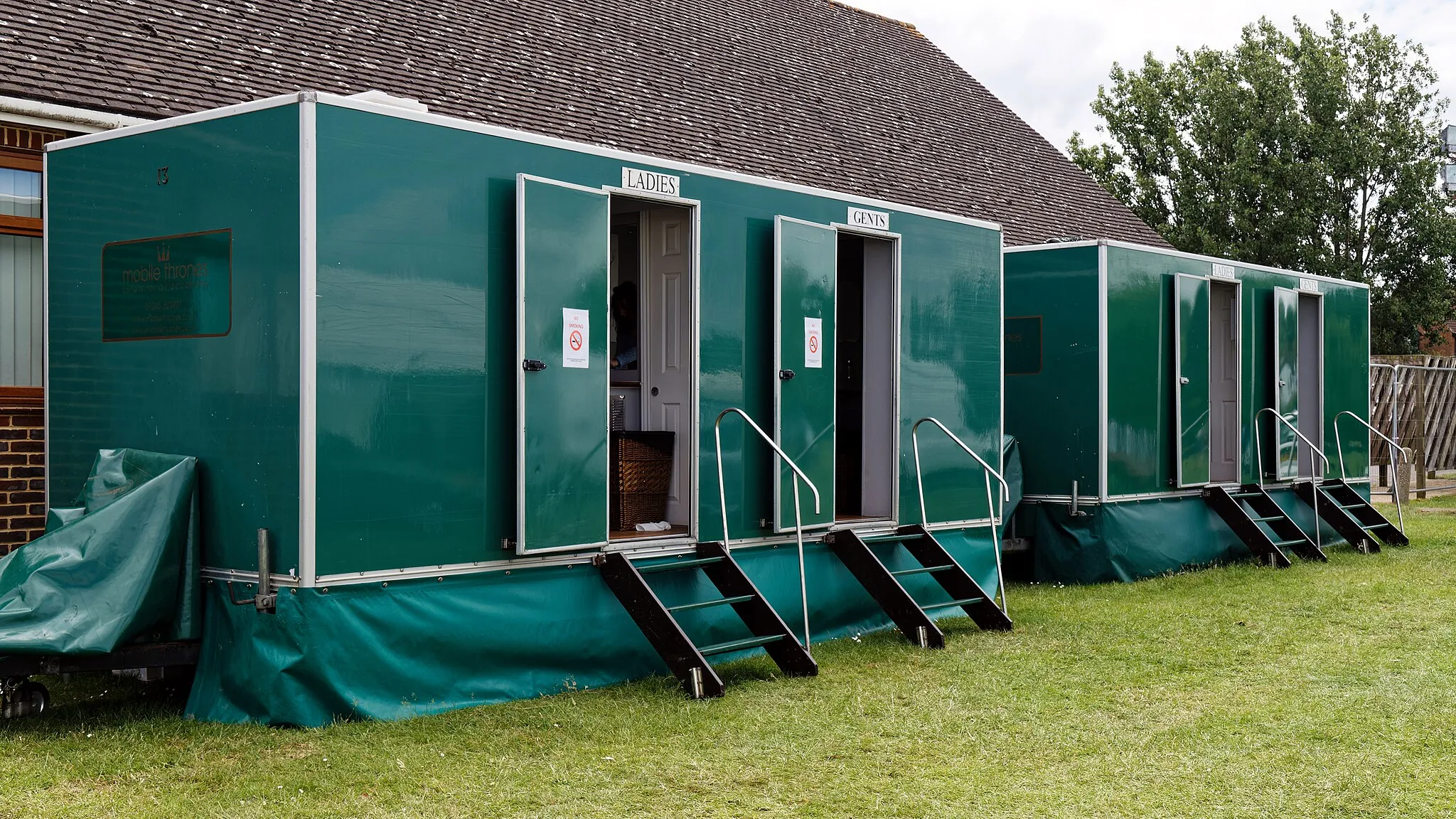 Photo showing: Lavatory toilet units at Abridge Village Weekend 2022 in Abridge, Essex, England. Mobile device view (2022): Wikimedia makes it difficult to immediately view photo groups related to this image. To see its most relevant allied photos, click on Abridge, and this uploader's photos. You can add a beta click-through 'categories' button to the very bottom of photo-pages you view by going to settings... three-bar icon top left. Desktop view (2022): Wikimedia makes it difficult to immediately view the helpful category links where you can find images related to this one in a variety of ways; for these go to the very bottom of the page. Camera: Canon EOS 6D Mark II with Canon EF 24-105mm F4L IS USM lens. Software: RAW file lens-corrected, optimized and converted with DxO PhotoLab 4 Elite, and further optimized with Adobe Photoshop CS2.