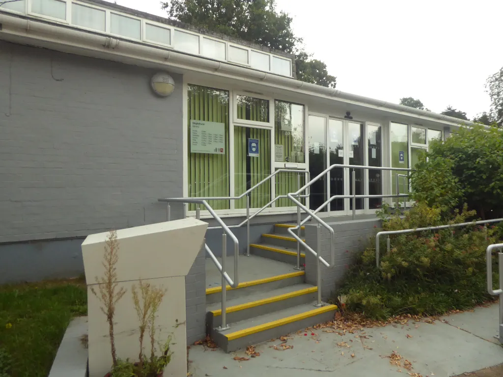 Photo showing: A return visit to Staplehurst - and the library looks different. Not only have the small bushes we saw in 2018 now grown almost to roof height, but the library has now ben painted grey. Looks very smart (and probably longer lasting than its previous white colour scheme).