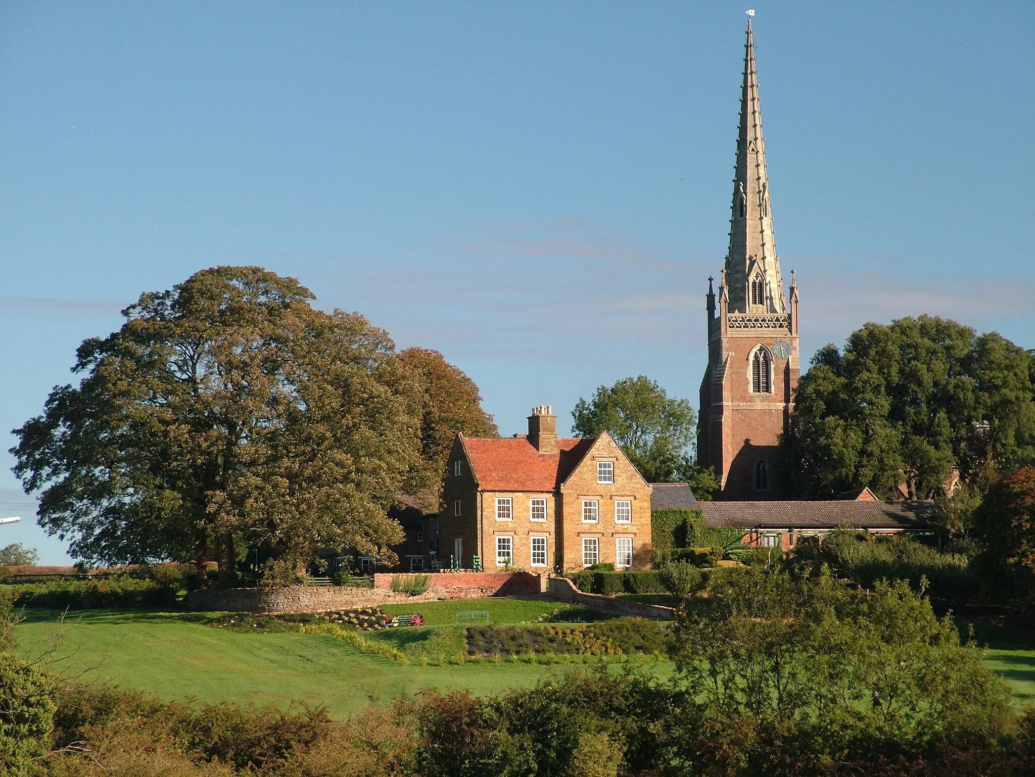 Photo showing: All Saint's church and the Manor house in Braunston, Northamptonshire, England.

Photograph by James Thompson