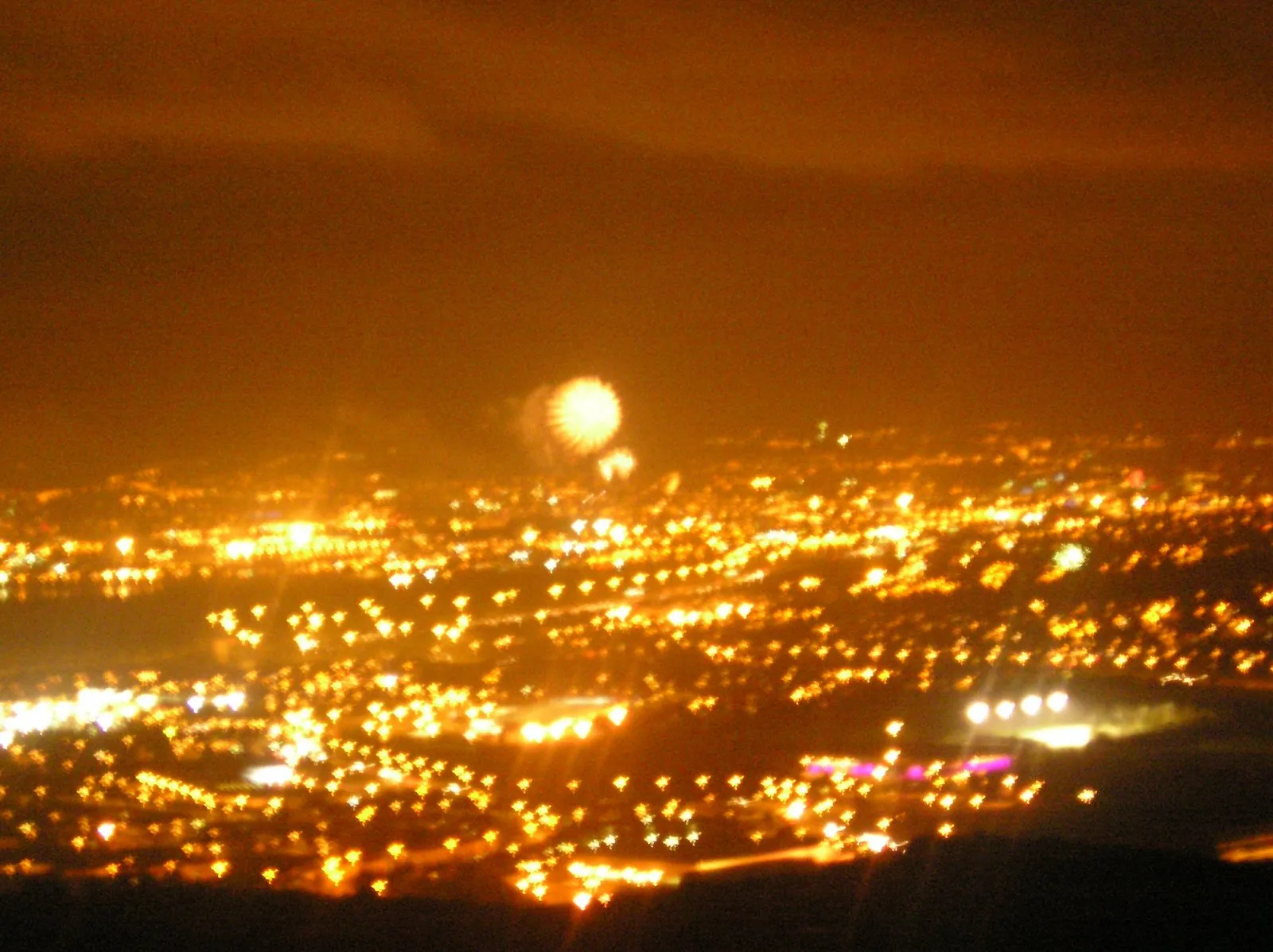 Photo showing: The view of Belfast from Carnmoney Hill (fireworks form the New Years celebrations can clearly be seen in the skies above Belfast's Odyssey Arena)