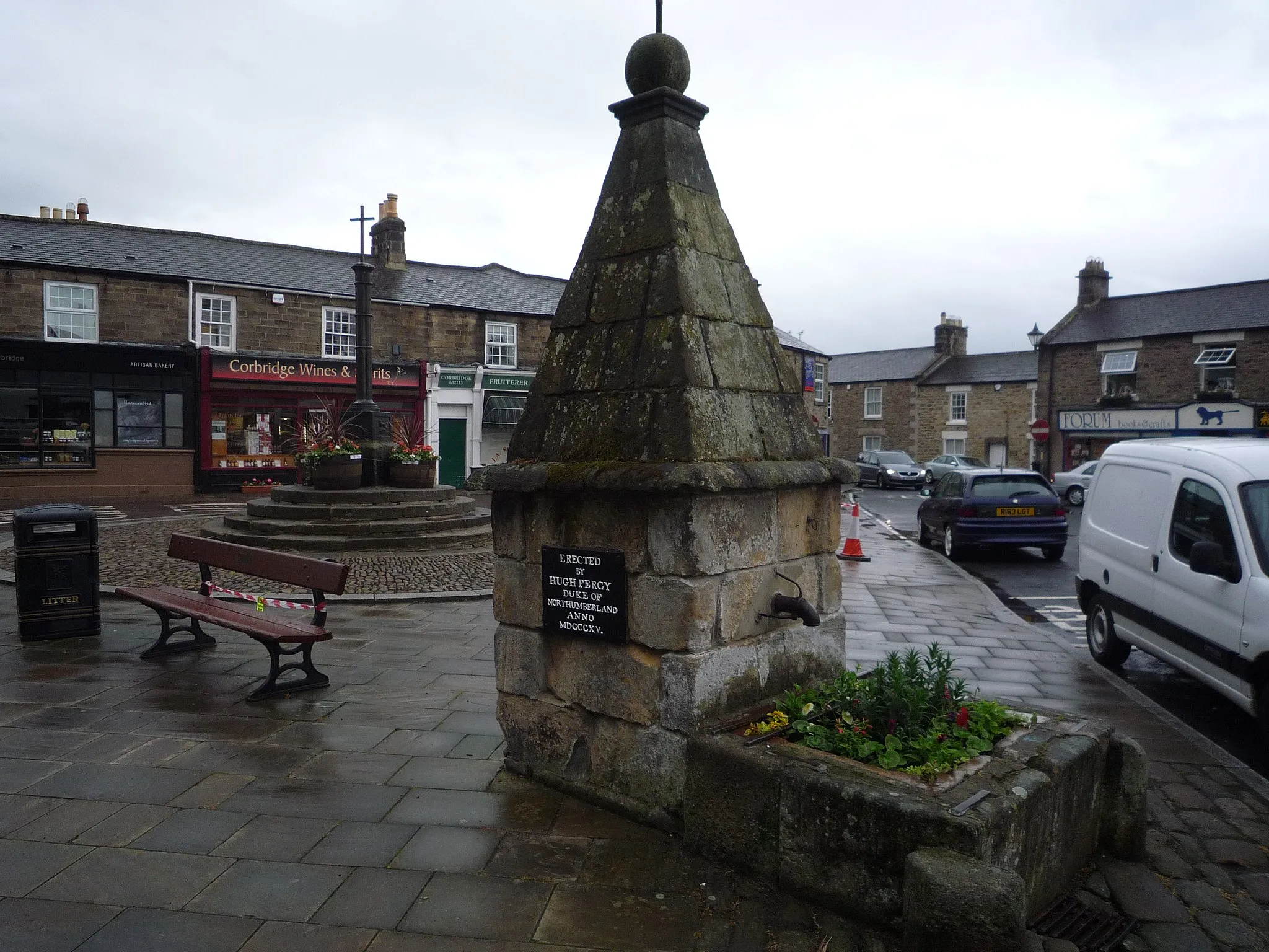 Photo showing: The pant (water supply fountain) in Market Place, Corbridge, Northumberland, England.
The plaque reads: Erected by Hugh Percy, Duke of Northumberland. Anno. MDCCCXV (1815).
Entry on the PMSA website.

The Market Cross is in the background.