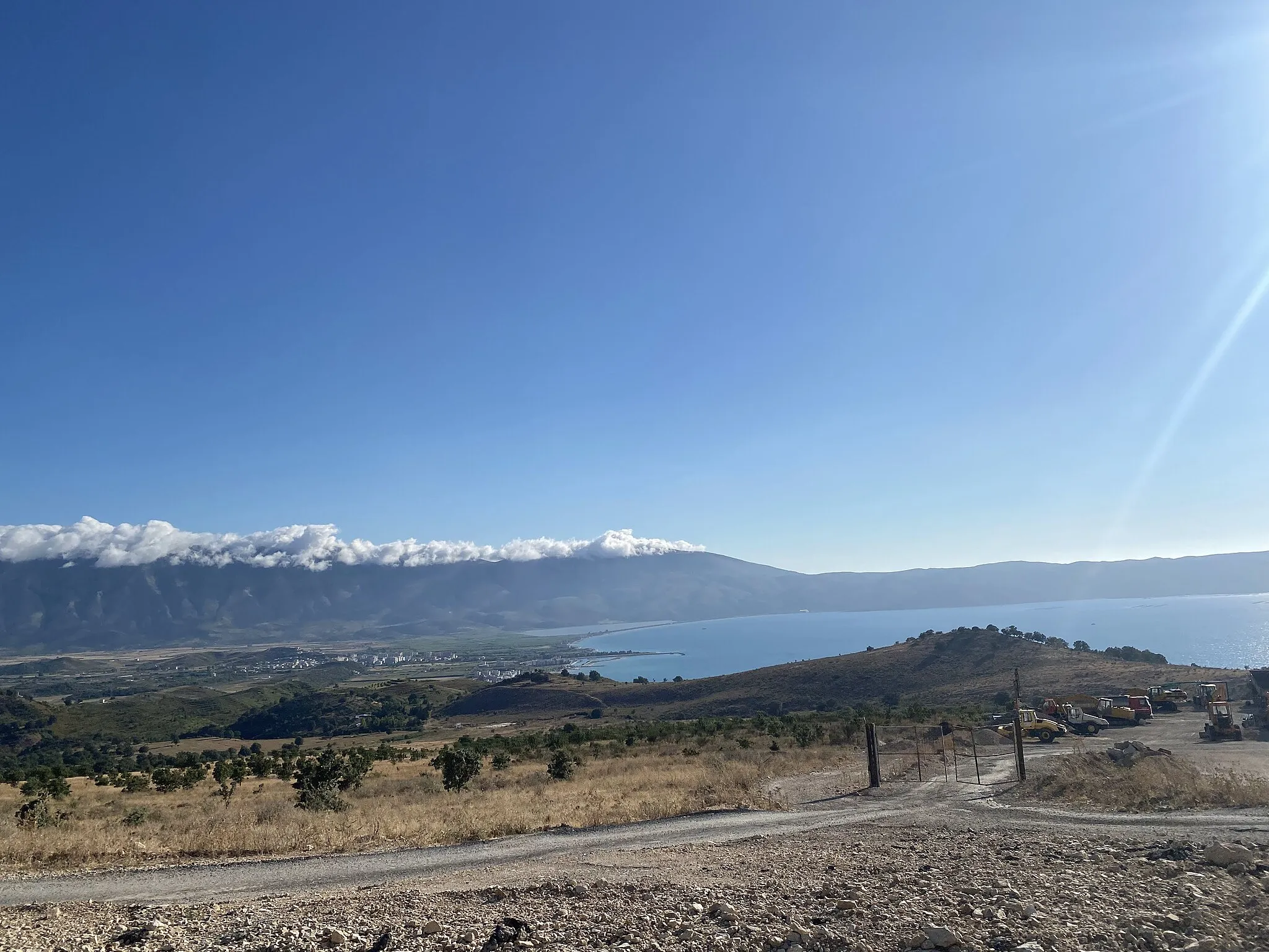 Photo showing: Orikum is situated in the Vlora Bay. The view from high ground shows its extension and the Karaburun Peninsula in the background