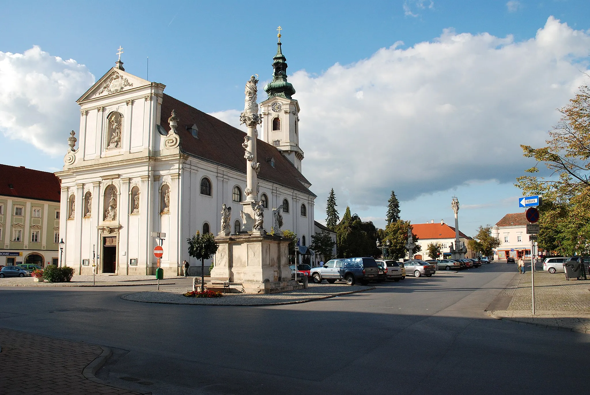 Photo showing: Main square of Bruck an der Leitha with church. In the foreground stands the column of Virgin Mary.
