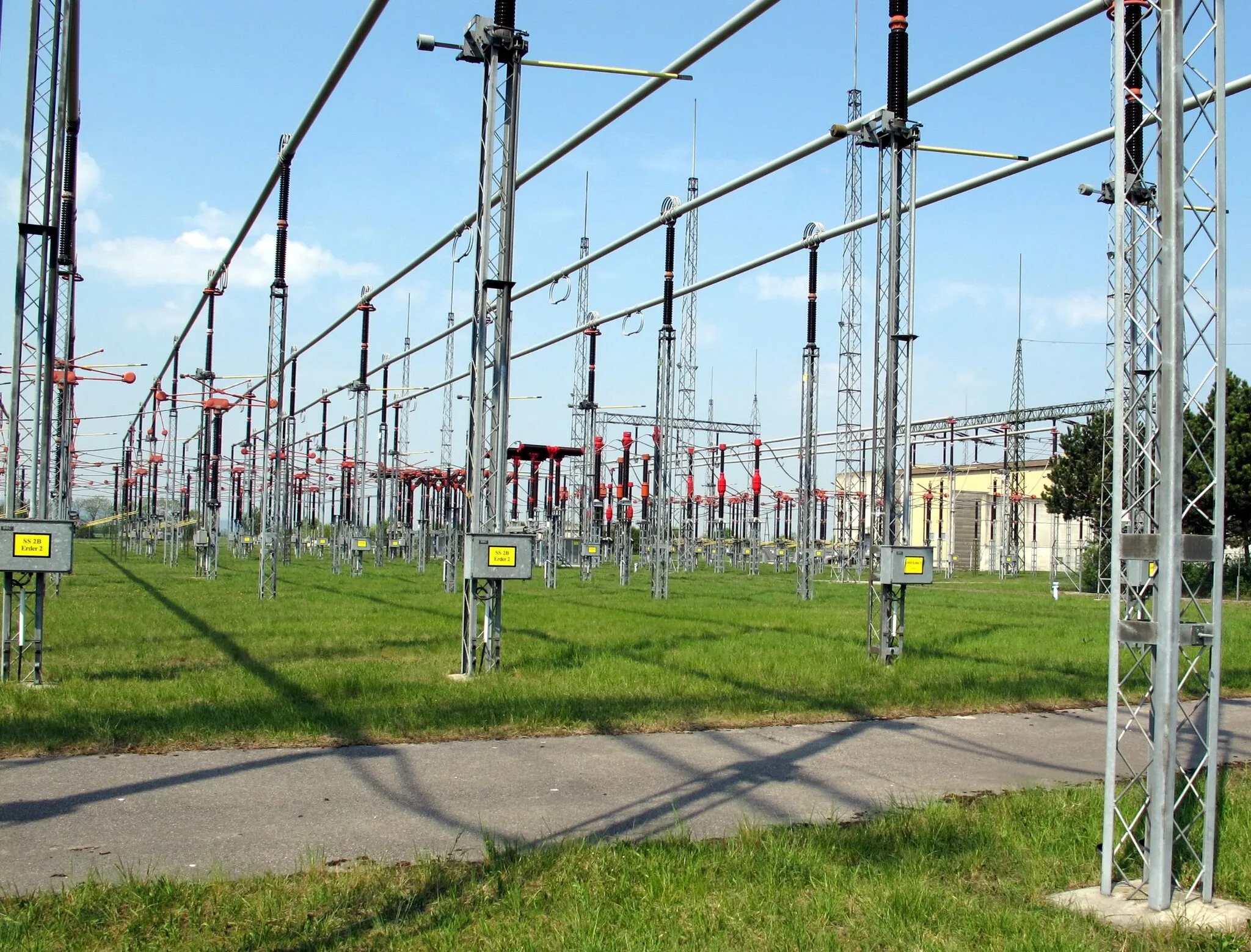 Photo showing: Umspannwerk Dürnrohr; Westliches 380-kV-Freiluftschaltfeld. Rechts im Hintergrund die Konverterhalle der ehemaligen GKK Dürnrohr und Abgang der 380-kV-Leitungen nach Slavětice (Tschechien)