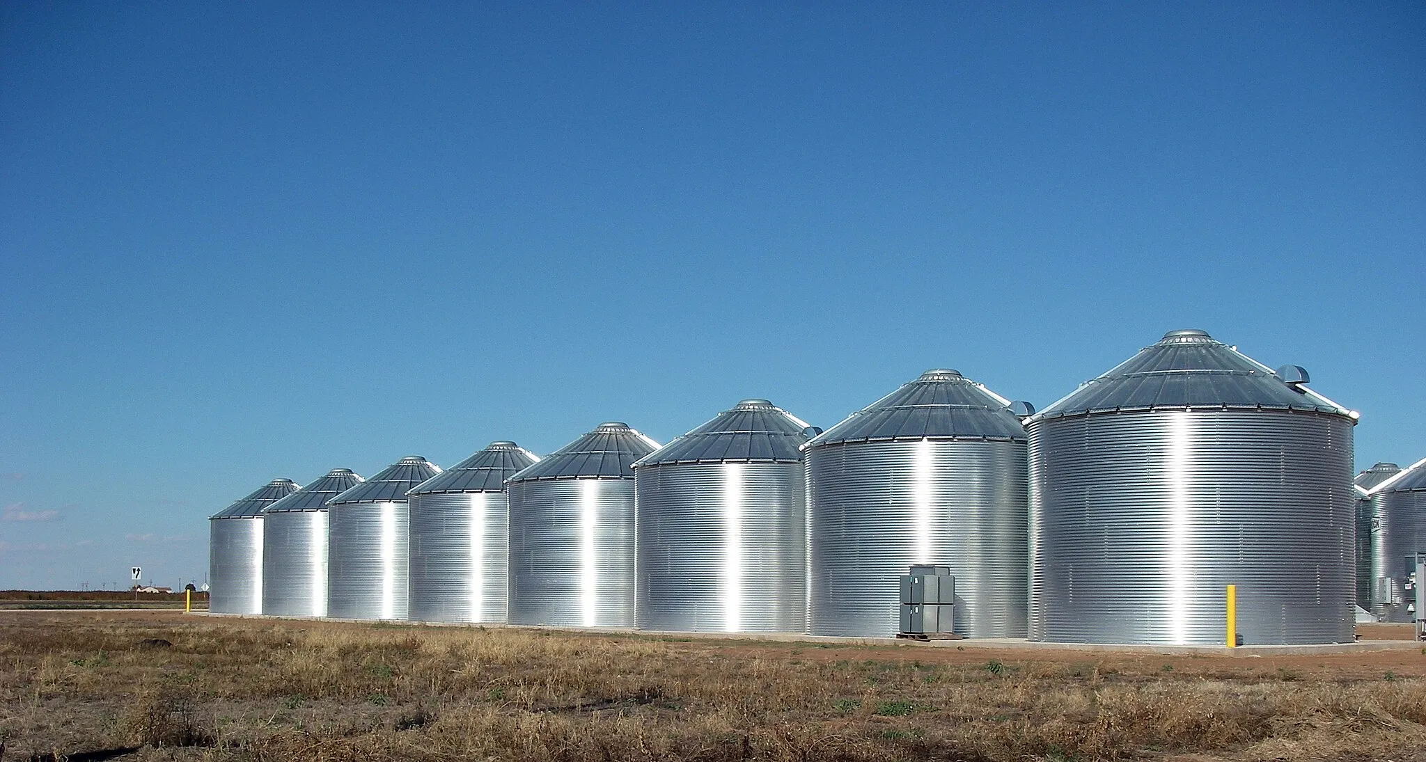 Photo showing: Steel silos storing sunflower seed along the west side of the small West Texas town of Ralls, Texas.