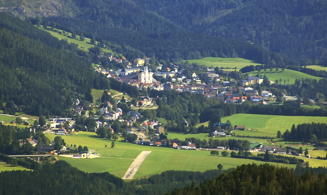 Photo showing: The city of Mariazell in the Austrian province of Steiermark, seen from Rauer Kamm. The runway of Mariazell Airport can be seen in the foreground.