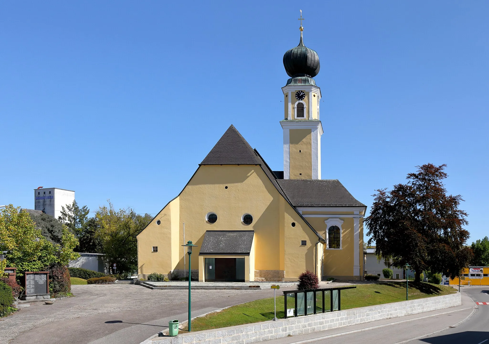 Photo showing: Westansicht der röm.-kath. Pfarrkirche hl. Mauritius in der oberösterreichischen Marktgemeinde Aurolzmünster. Ursprünglich eine spätgotische Kirche, die von 1729 bis 1735 im Barockstil aus- und umgebaut wurde. Der an der Südseite der Kirche angebaute Turm trug vor dem Brand im Jahre 1672 ein Spitzdach. 1718 wurde der Zwiebelhelm aufgebracht.