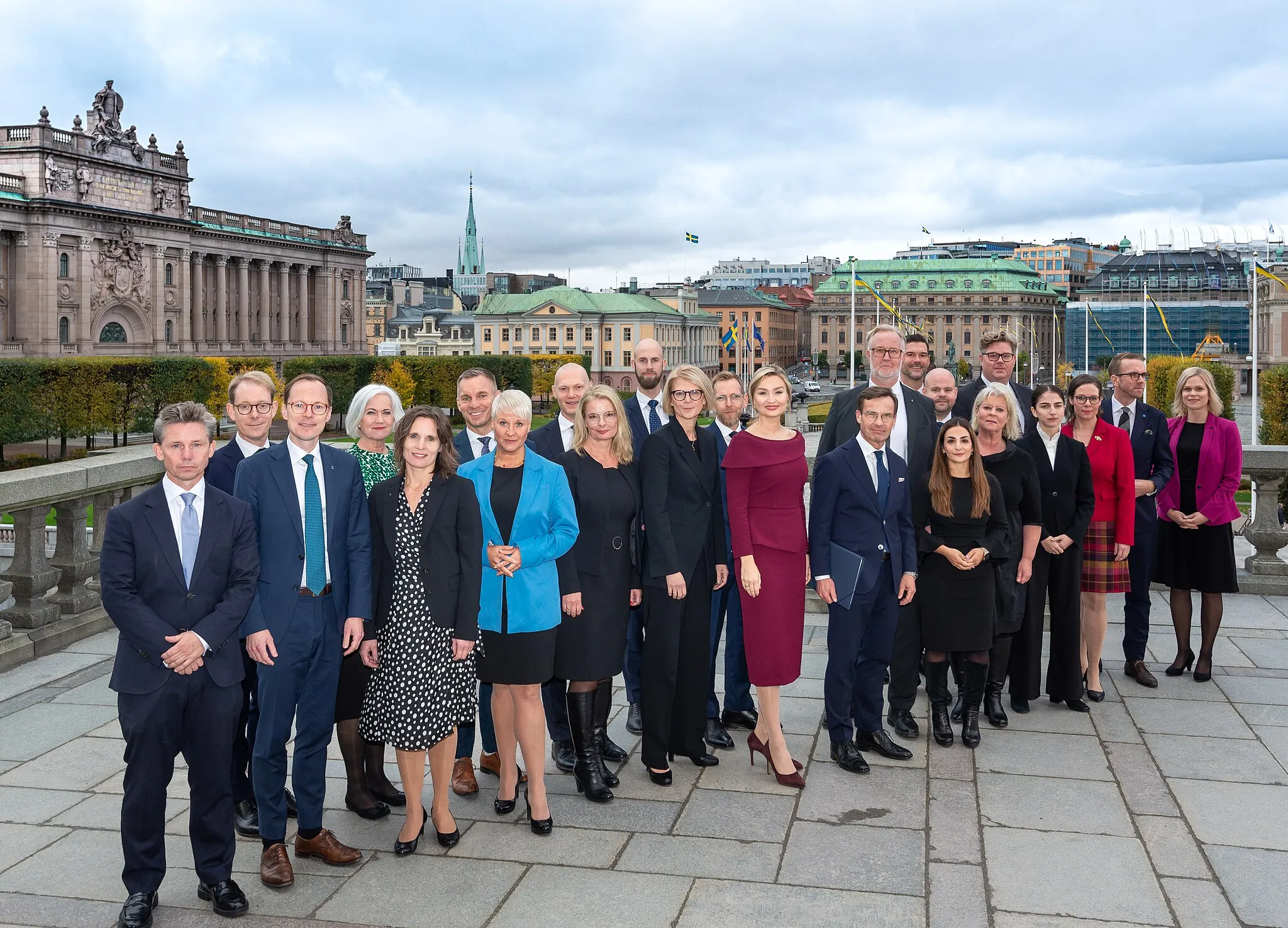 Photo showing: Newly appointed Kristersson Cabinet gathered at Lejonbacken outside the royal palace after the meeting with the King Carl XVI Gustaf on 18 October 2022.