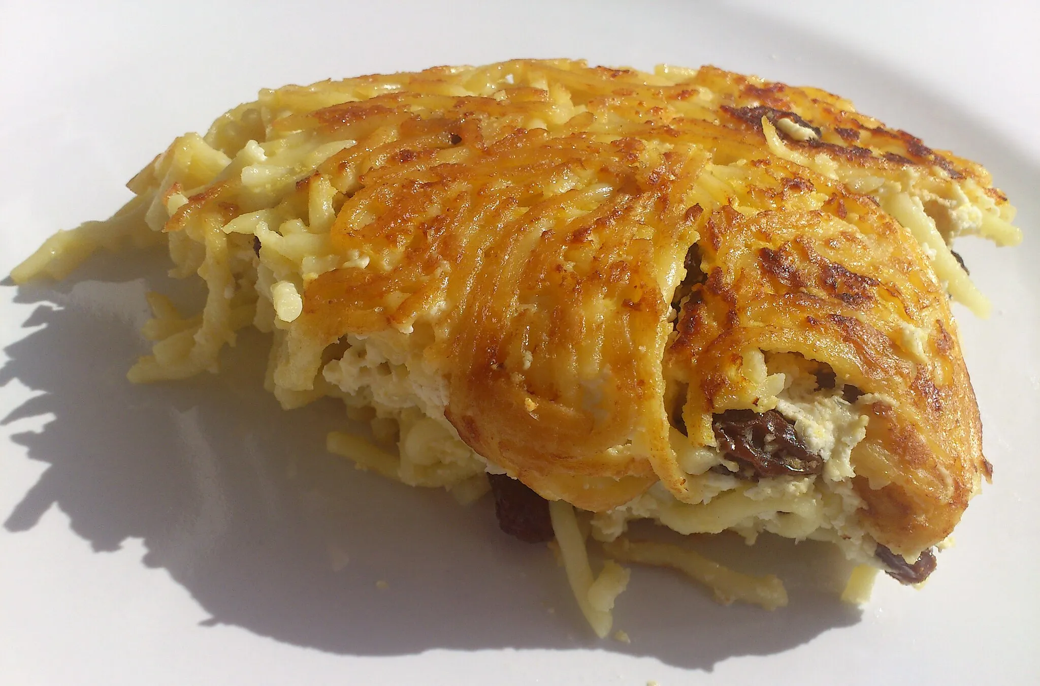 Photo showing: Noodle kugel made with curd cheese, eggs and raisins
