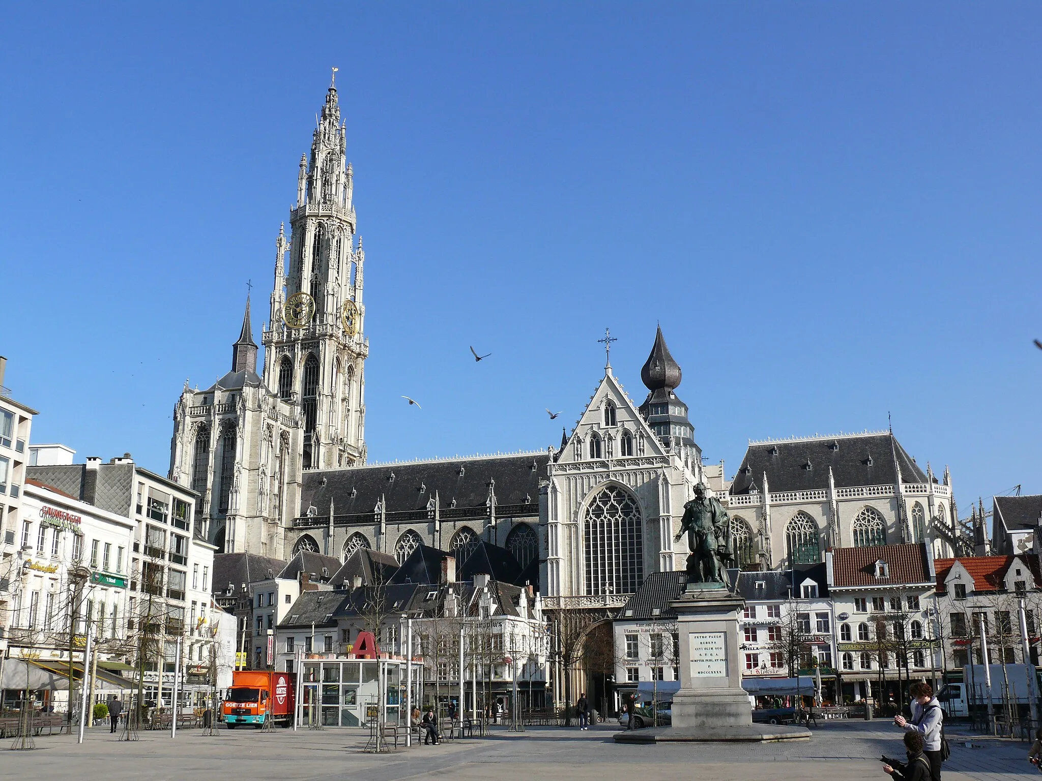 Photo showing: Our Lady's Cathedral, Antwerp, as seen from the Groenplaats.
The Groenplaats is a square in the centre of Antwerp. the square boasts a statue of Rubens, designed by Willem (Guillaume) Geefs (1805-1883) in 1840.

The Cathedral of Our Lady (Dutch: Onze-Lieve-Vrouwekathedraal ten Hemel Opgenomen) is a Roman Catholic parish church in Antwerp, Belgium. The today's see of the Diocese of Antwerp was started in 1352 and, although the first stage of construction was ended in 1521, has never been 'completed'. In Gothic style, its architects were Jan and Pieter Appelmans. It contains a number of significant works by the Baroque painter Peter Paul Rubens, as well as paintings by artists such as Otto van Veen, Jacob de Backer and Marten de Vos.