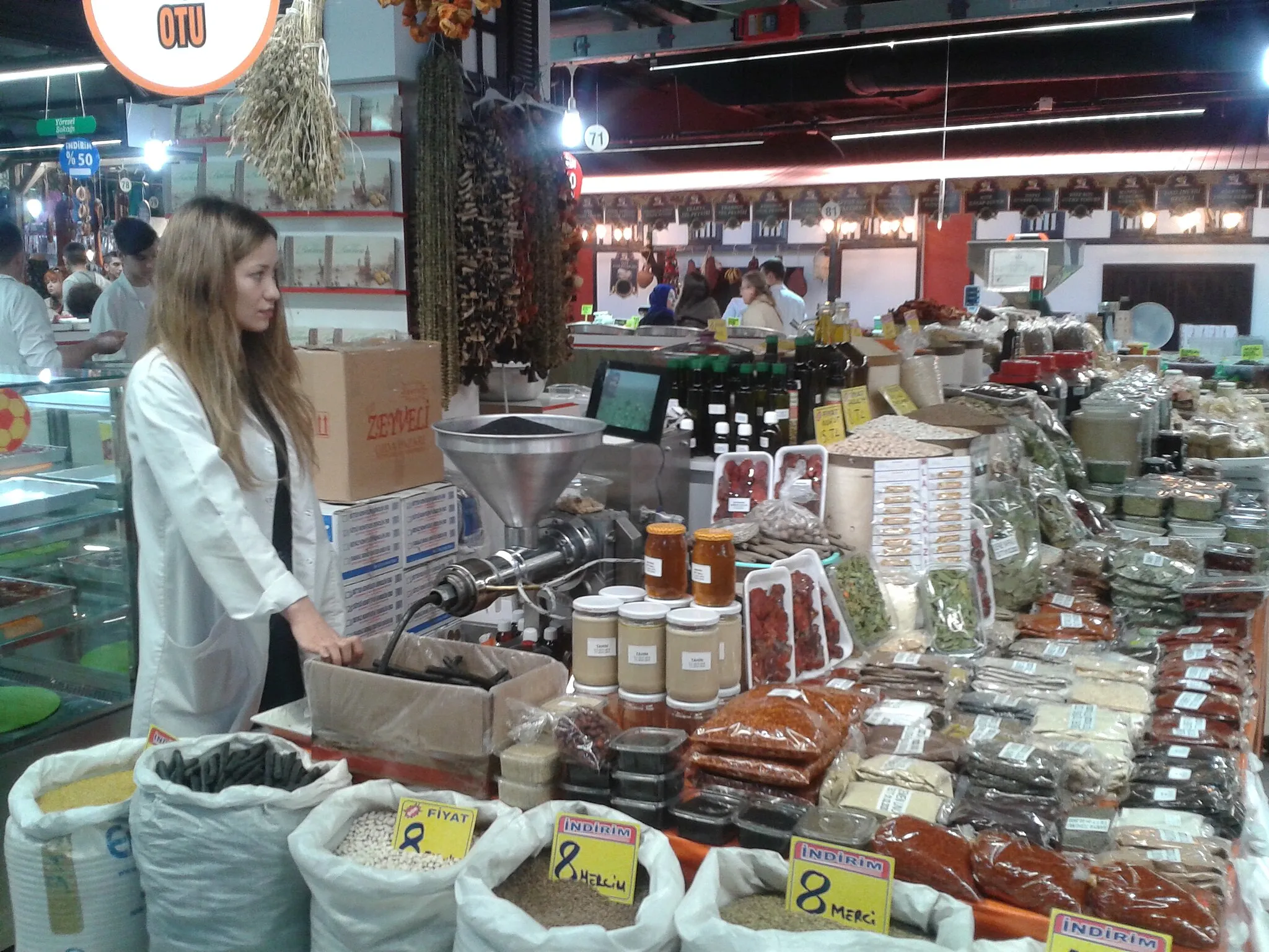 Photo showing: Ankara  - young saleswoman in a food market at Çankaya district.