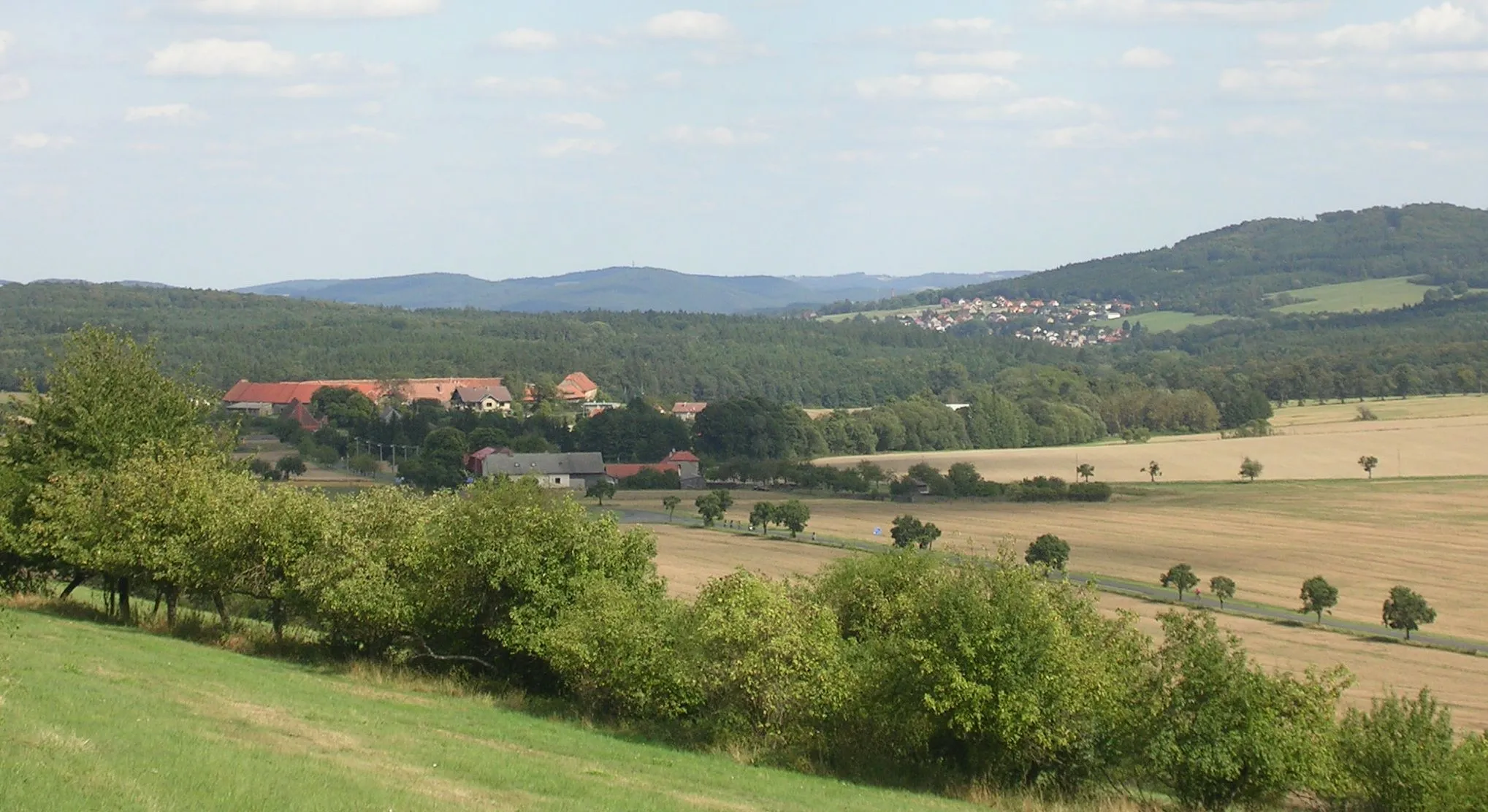 Photo showing: Rakovník District and Beroun District, Central Bohemian Region, the Czech Republic. A view of Karlov and Nový Jáchymov from a gap near Špička Hill.