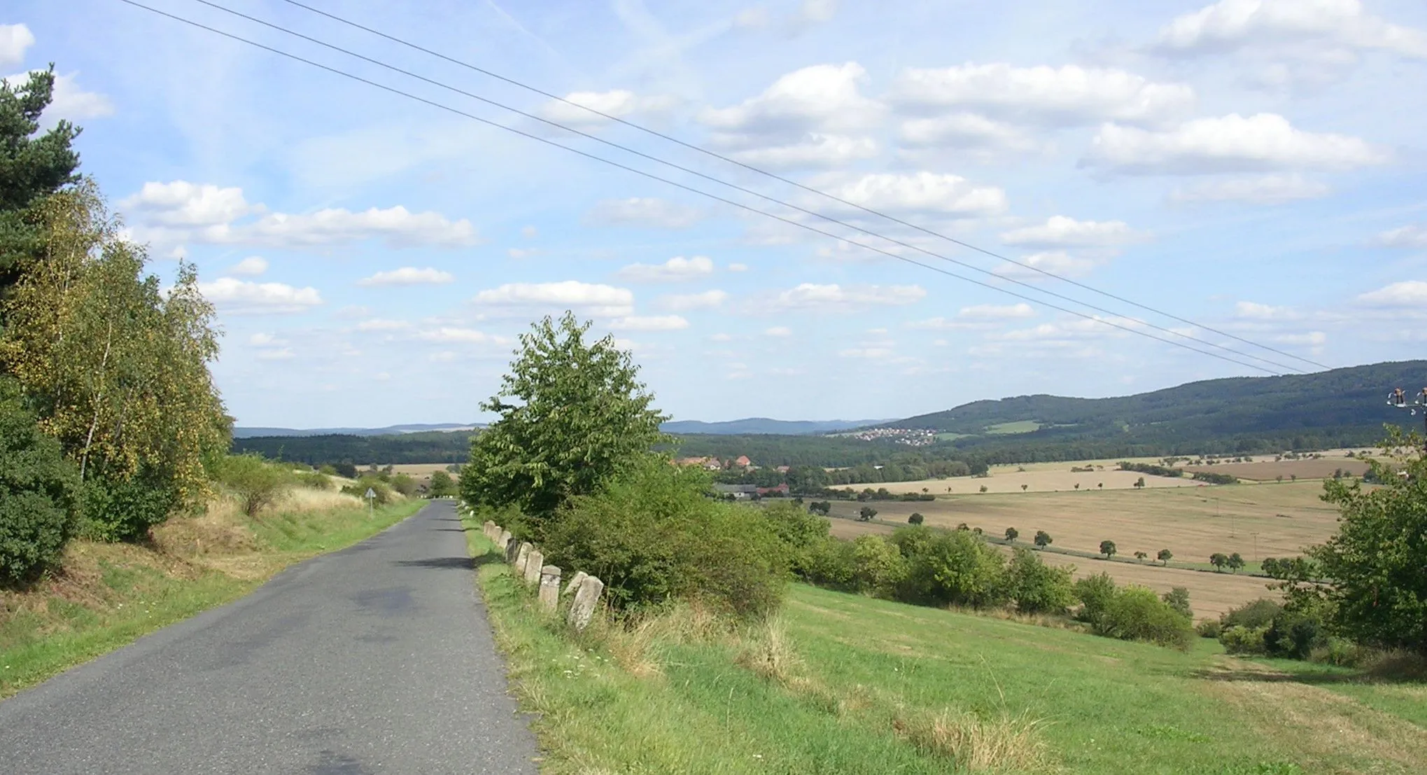 Photo showing: Rakovník District and Beroun District, Central Bohemian Region, the Czech Republic. A view of Karlov and Nový Jáchymov from a gap near Špička Hill.