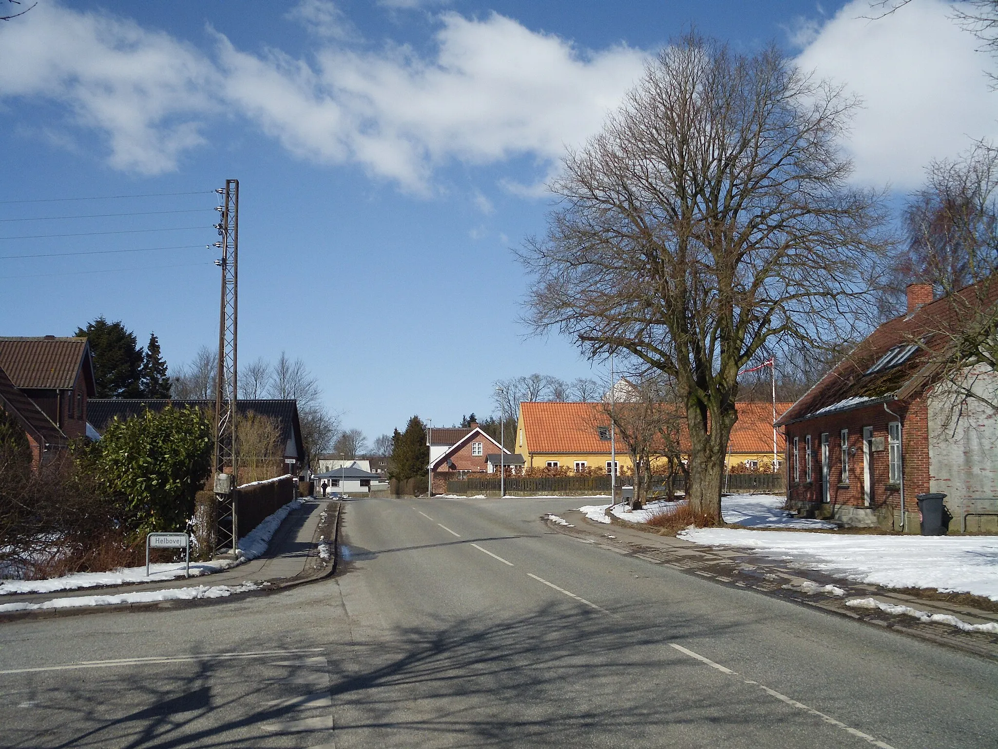 Photo showing: View of a center of Mejlby, a village outside Aarhus, Denmark, at a crossroads of Mejlbyvej (the main road) and Helbovej (turning left).