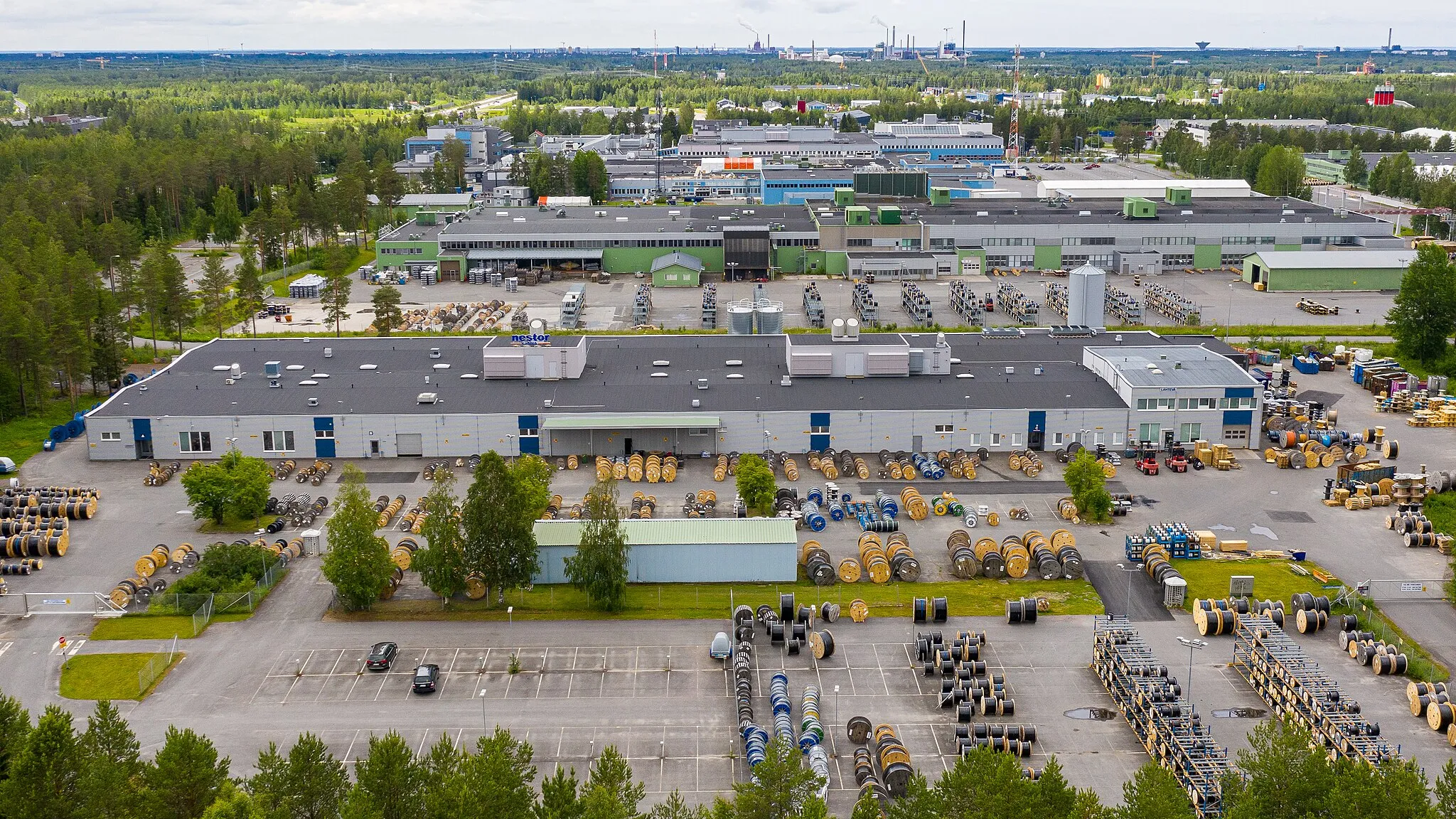 Photo showing: Nestor Cables Ltd cable factory in Ruskonselkä, Oulu, Finland. Nokia Corporation buildings in the background.