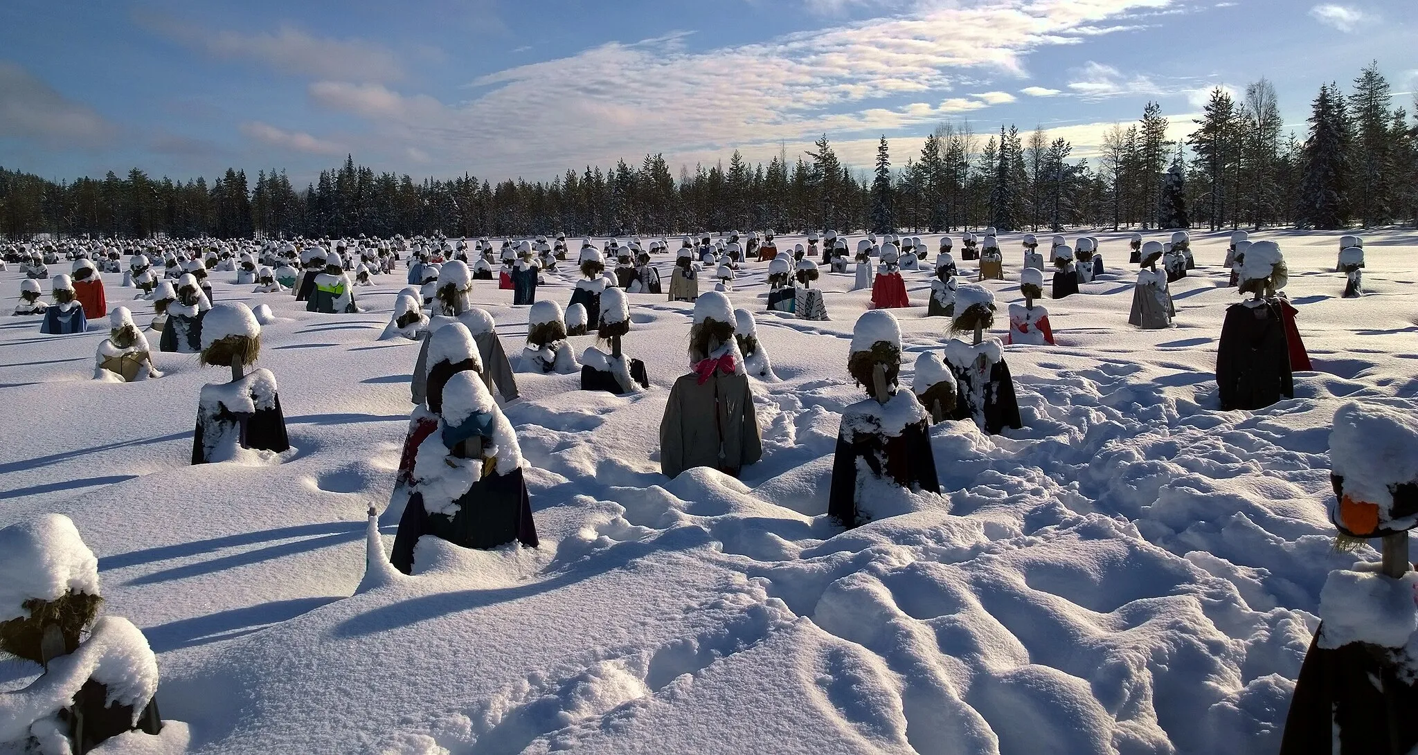 Photo showing: A crowd of frozen figures standing in a field near Suomussalmi, northern Finland