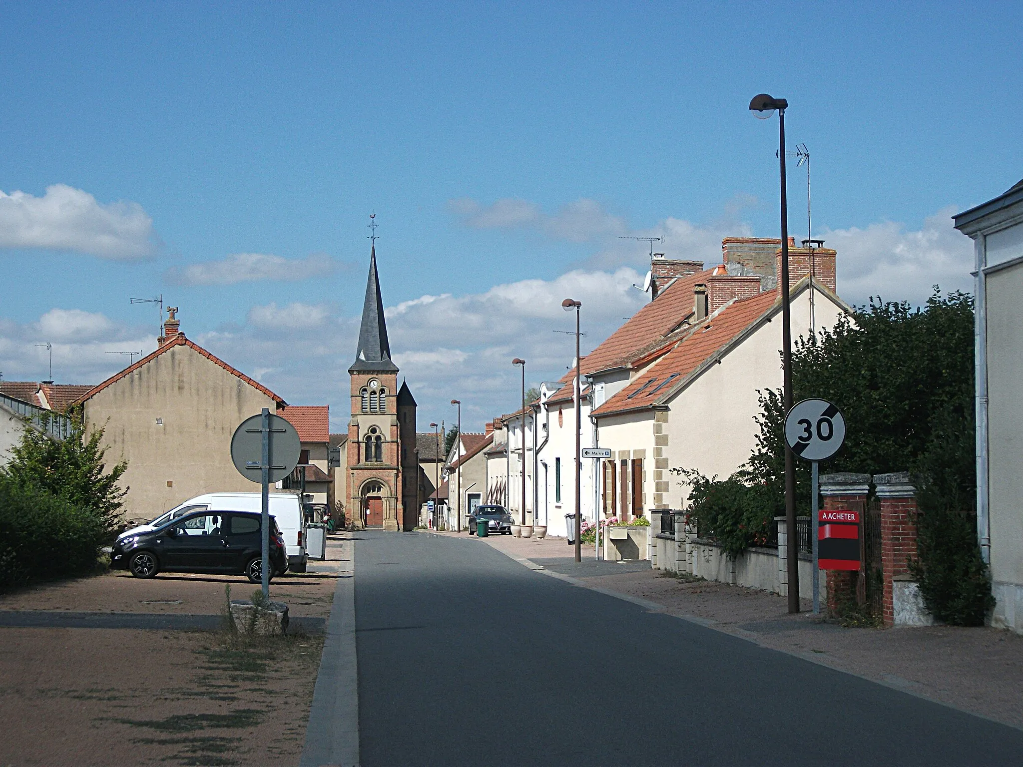Photo showing: Rue des Droits de l'Homme, in Verneix, Allier, Auvergne-Rhône-Alpes, France, with the church in the second ground. [16704]