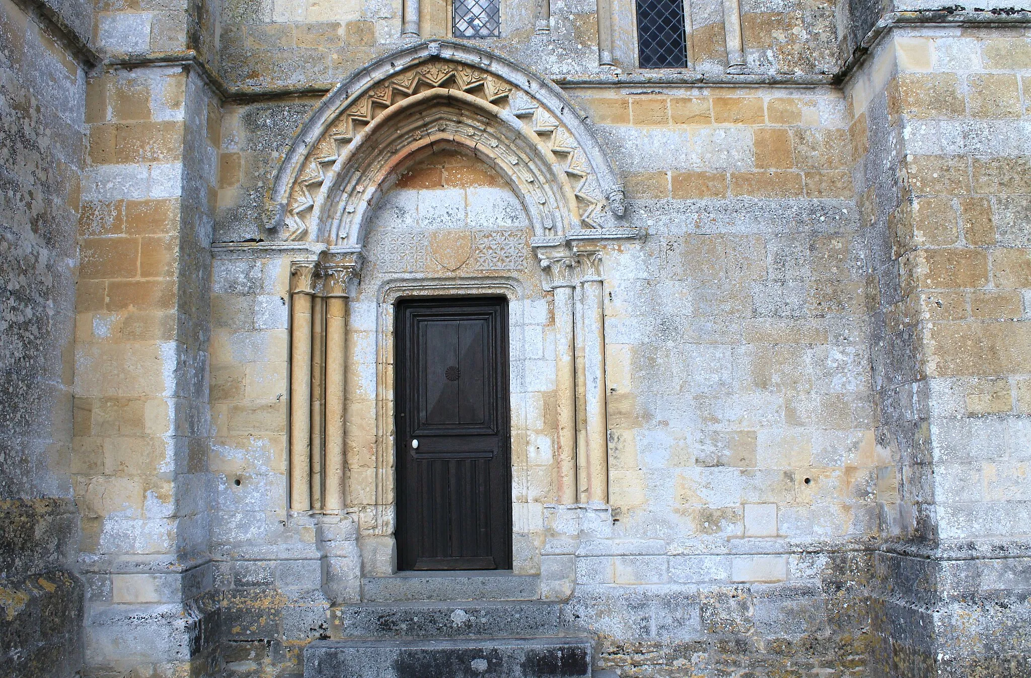 Photo showing: Portail latéral sud surmonté d'un bandeau couvert d'étoiles et d'un écusson, église Notre-Dame d'Ouville-la-Bien-Tournée (Calvados)
