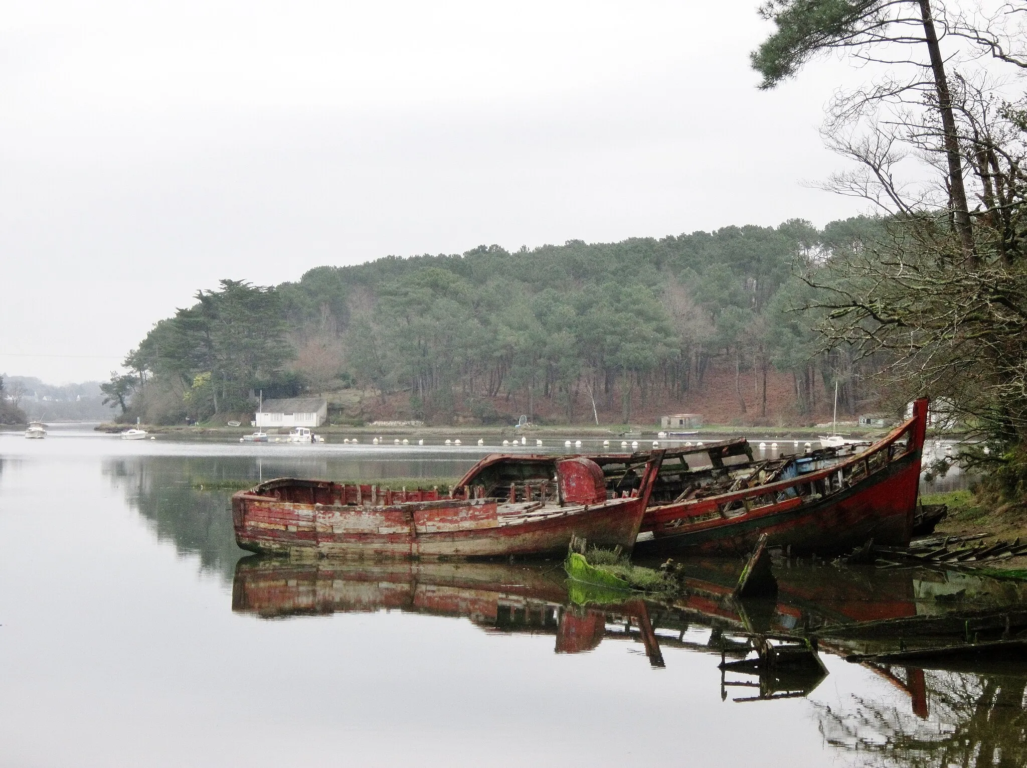 Photo showing: L'épave du Aimons-nous dans le cimetière de bateaux de l'Anse du Govillo ; à l'arrière-pan la rive gauche de la Rivière du Bono en Le Bono.