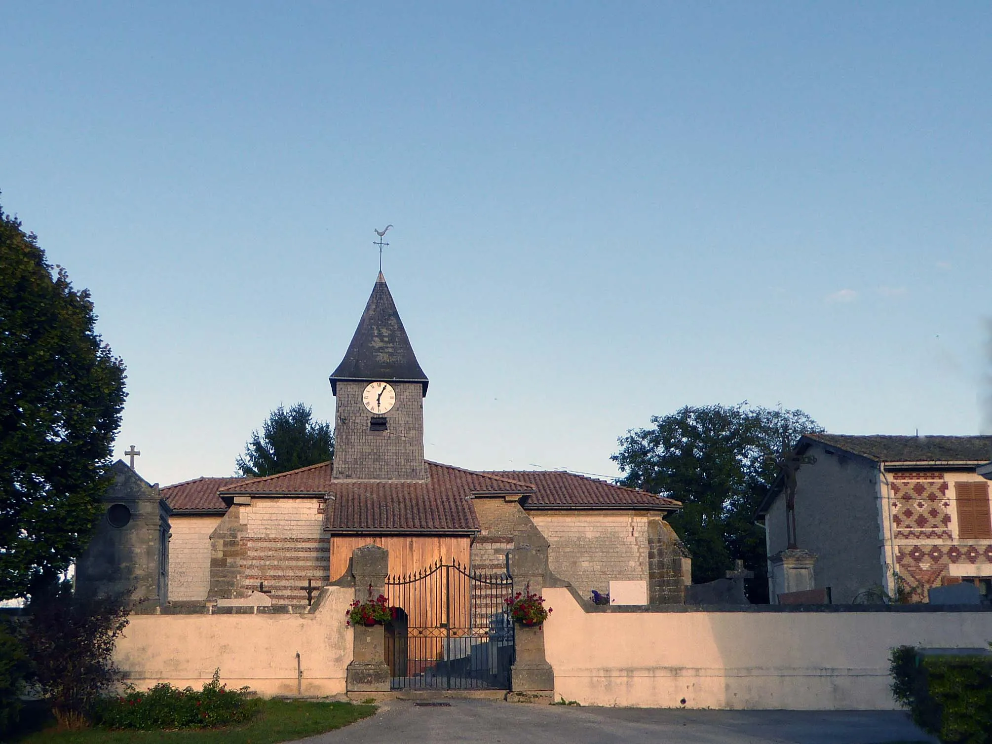 Photo showing: Entourée du cimetière clos, à côté maison à la façade décorée