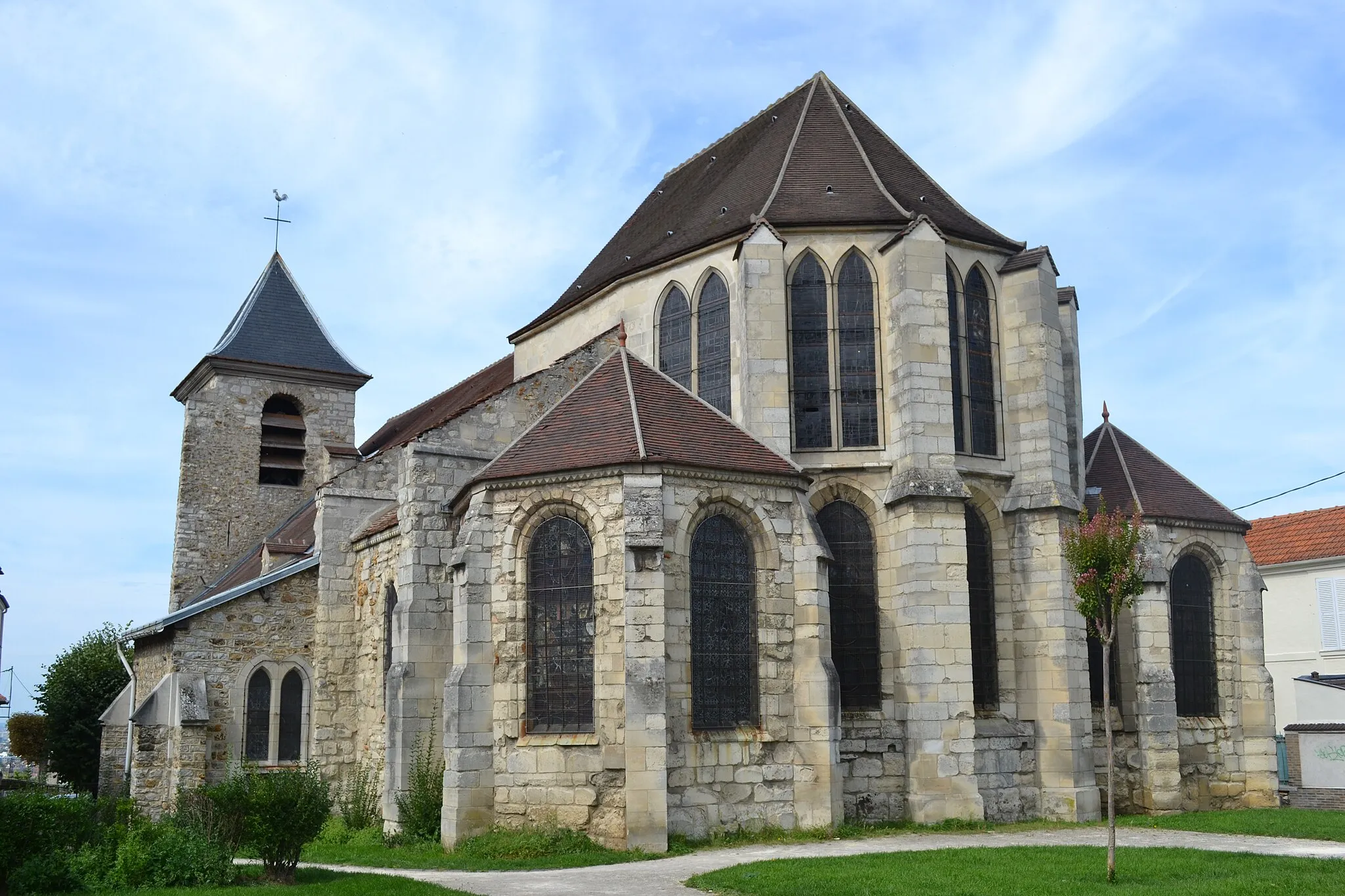 Photo showing: Le devant de l'église est masqué par des arbres. Cependant le chevet est peut-être sa partie la plus intéressante.