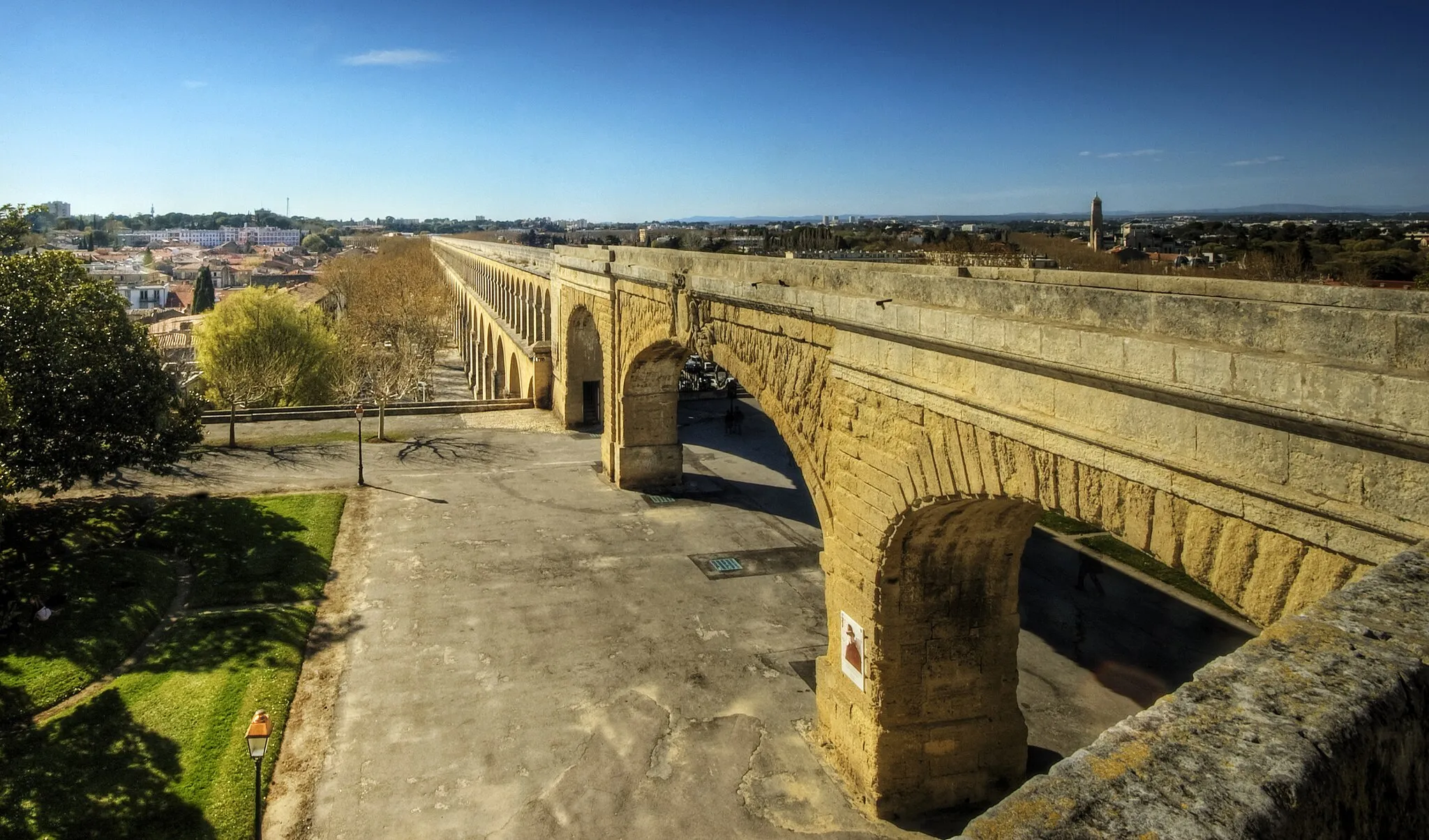 Photo showing: The ancient Romans constructed numerous aqueducts to supply water to cities and industrial sites. These aqueducts were amongst the greatest engineering feats of the ancient world, and set a standard not equalled for over a thousand years after the fall of Rome. Many cities, such as Segovia, still maintain and use the ancient aqueducts for their water supply even today.
The Romans typically built numerous aqueducts to serve any large city in their empire, as well as many small towns and industrial sites. The city of Rome itself, being the largest city, had the largest concentration of aqueducts, with water being supplied by eleven aqueducts constructed over a period of 500 years. They served potable water and supplied the numerous baths and fountains in the city, as well as finally being emptied into the sewers, where they performed their last function in removing waste matter. The methods of construction are well described by Vitruvius in his work De Architectura written in the first century BC. His book would have been of great assistance to Frontinus, a general who was appointed in the late first century AD to administer the many aqueducts of Rome. He discovered a discrepancy between the intake and supply of water caused by illegal pipes inserted into the channels to divert the water, and reported on his efforts to improve and regulate the system to the emperor Nerva at the end of the first century AD. The report of his investigation is known as De aquaeductu.
In addition to masonry aqueducts, the Romans built many more leats; channels excavated in the ground, usually with a clay lining. They could serve industrial sites such as gold mines, lead and tin mines, forges, water-mills and baths or thermae. Leats were very much cheaper than the masonry design, but all aqueducts required good surveying to ensure a regular and smooth flow of water.

From Wikipedia, the free encyclopedia