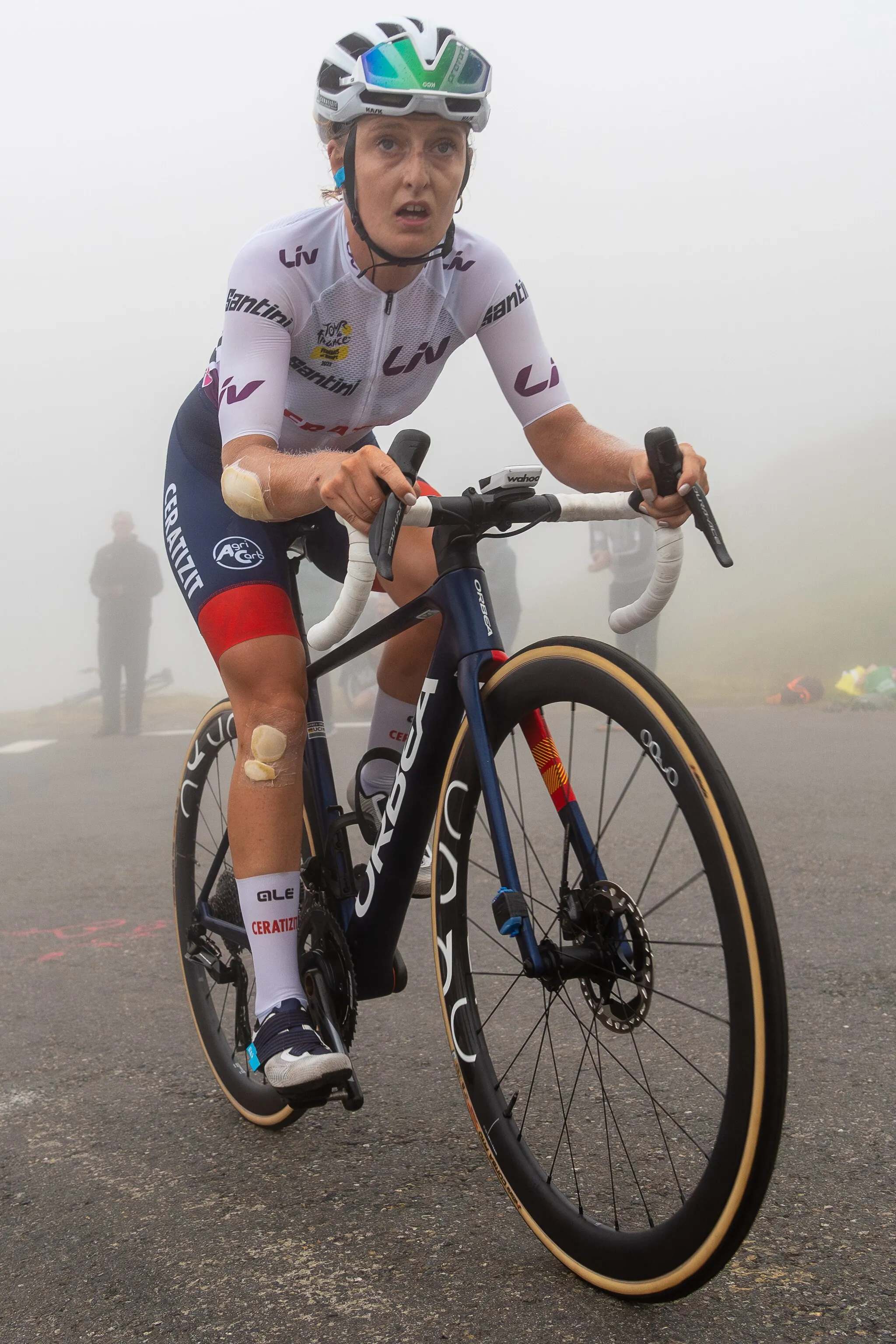 Photo showing: Cedrine Kerbaol wearing the jersey of best young rider in the 2023 Tour de France for Women as she climbs the Col du Tourmalet.