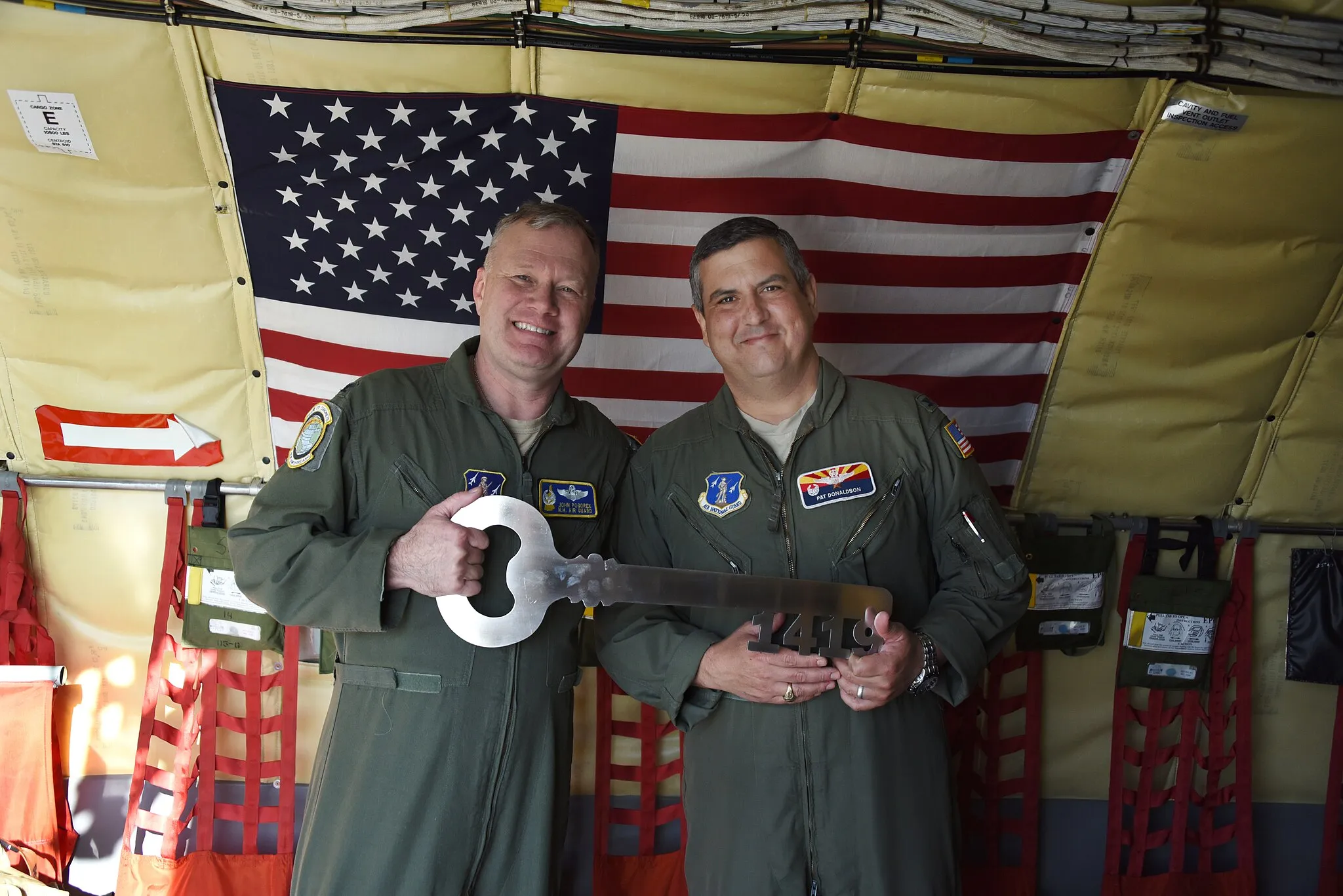 Photo showing: Colonel John Pogorek, commander, 157th Air Refueling Wing, Pease Air National Guard Base, N.H., hands over the key to KC-135 Stratotanker 57-1419 to Colonel Patrick Donaldson, commander, 161st  Air Refueling Wing, Goldwater Air National Guard Base, Phoenix, March 24, 2019. Pease Air National Guard Base held a divesture ceremony for the aircraft and will soon become home to the newest Stratotanker, the KC-46A Pegasus.  (U.S. Air National Guard/Master Sgt. Kelly Deitloff)