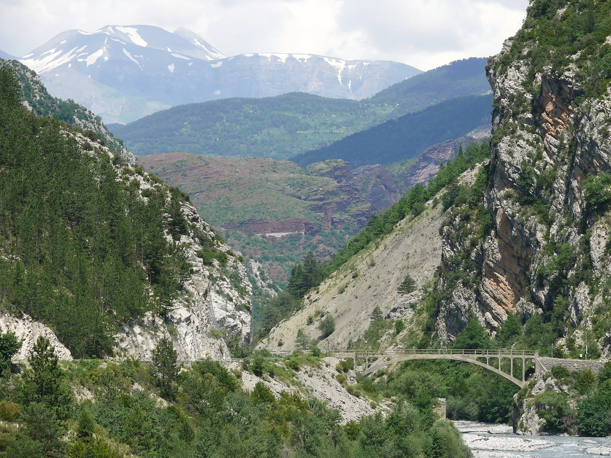 Photo showing: Daluis - Vallée du Var - Pont de la D316 vers la Vignasse et Saint-Léger. En arrière-plan les roches rouges du Dôme de Barrot, puis au fond le Mont-Mounier (2817 m) enneigé.