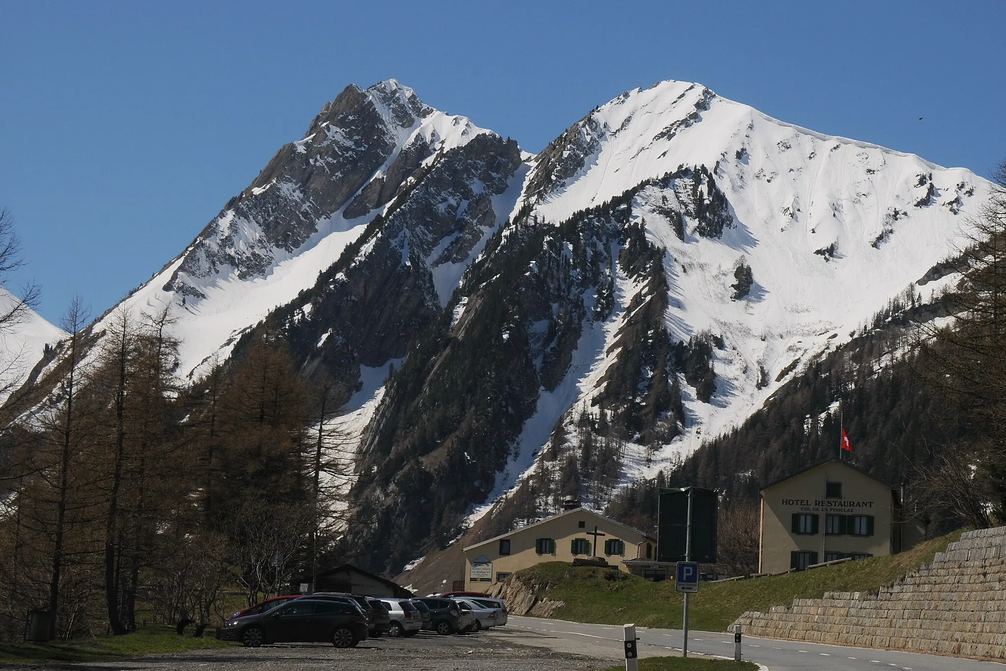 Photo showing: Col de la Forclaz with restaurants and the 2 mountains Croix de Fer (2343) and Tete de Balme (2319) and at 5 May 2016