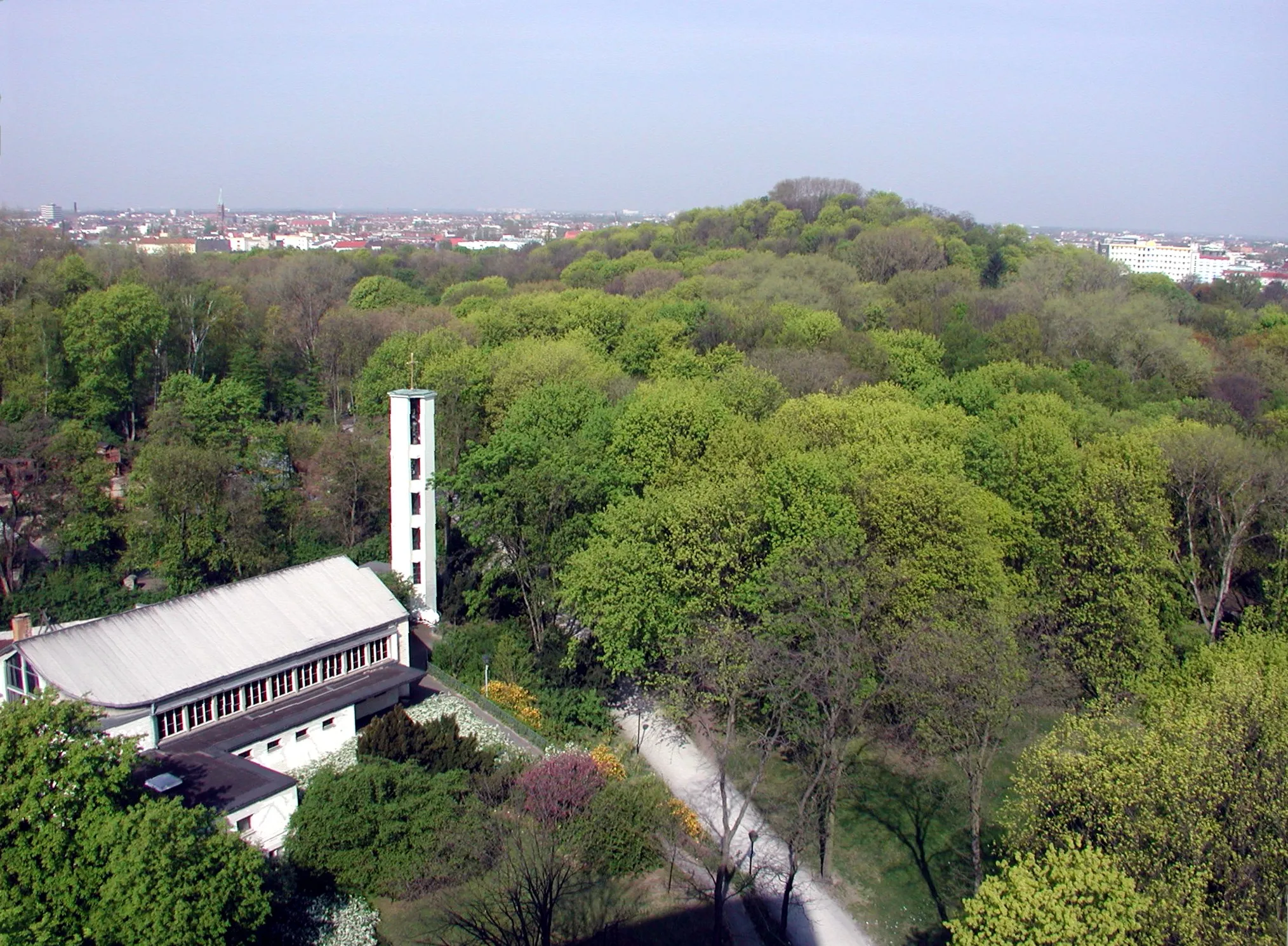 Photo showing: The Park of Humboldthain, with Humboldthöhe hight and the Ascension of Jesus Church, in Gesundbrunnen, Berlin, Germany. The Ascension Church is owned and used by a congregation within the Evangelical Church of Berlin-Brandenburg-Silesian Upper Lusatia, a united Protestant church body of Calvinist, Lutheran and united congregations. The church building is also used by way of rent contract as a simultaneum with the Syriac Orthodox congregation of St. Izozoel, which consecrated the church to that Saint.