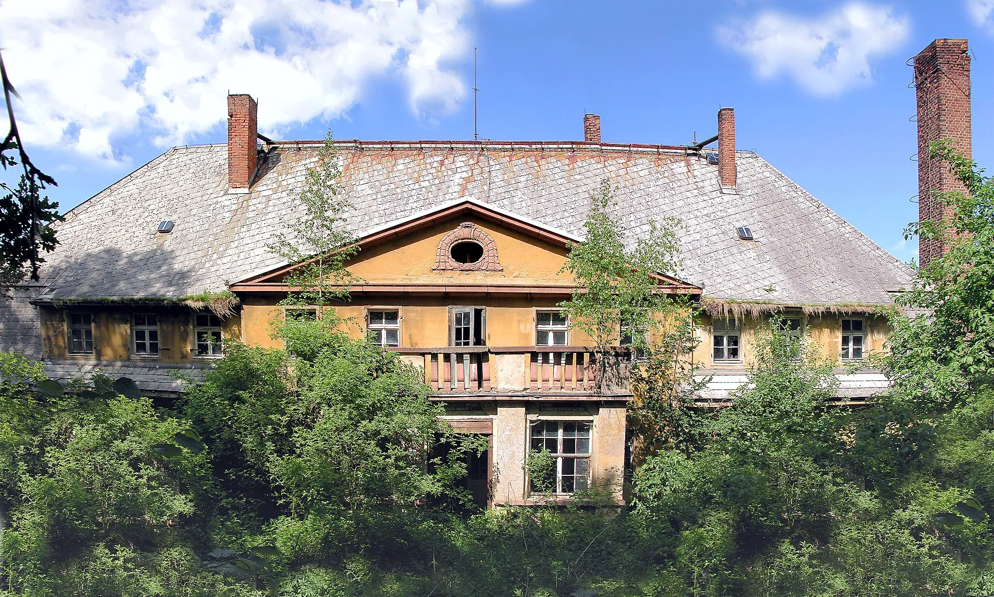 Photo showing: 24.05.2006   04720  Ebersbach (Döbeln), Am Rittergut (GMP: 51.096599,13.130426): Verfallendes Herrenhaus des ehemaligen Ritterguts. Es war im 17. Jahrhundert im Besitz der Marschälle von Bieberstein, es folgten verschiedene Adelsfamilien und bürgerliche Eigentümer. Das Herrenhaus aus dem 18. Jahrhundert erhielt 1922 ein neues Portal und einen wappengeschmückten Giebel. Aus dem 1945 enteigneten Rittergut wurde in der DDR ein Volksgut. 1990 mußte es seinen Betrieb einstellen. Das Gut wurde privatisiert, seitdem verfällt es. Sicht aus dem Park von Süden.                                                                                                                                                                        [DSCN10252-10254.TIF]20060524195MDR.JPG(c)Blobelt