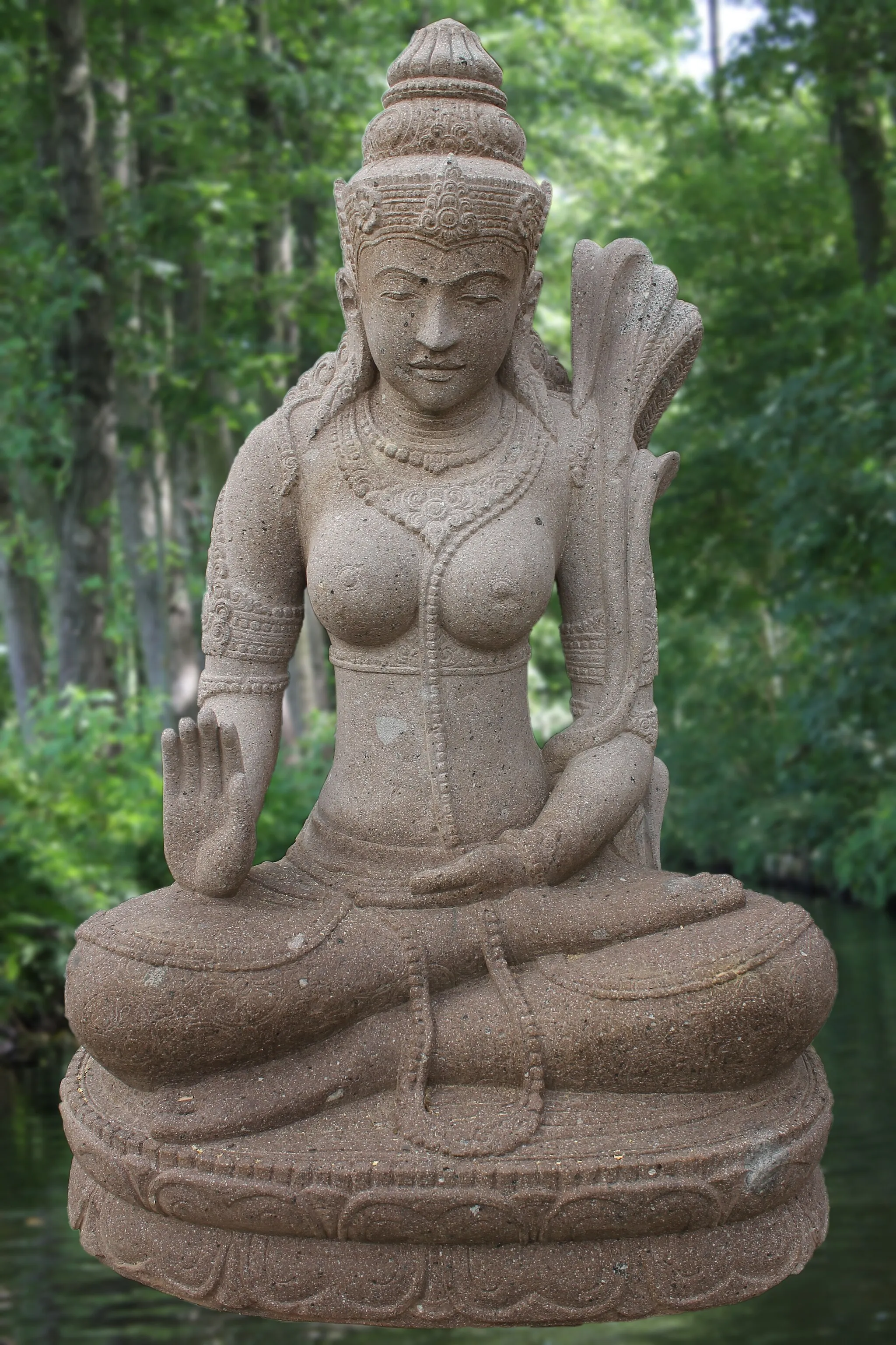 Photo showing: This is the stone figure of Dewi Sri Abhaya Mudra, an Indonesian rice goddess of fertility. The sculpture consists of the natural stone Rhyolih and was handcrafted in Java (Indonesia).